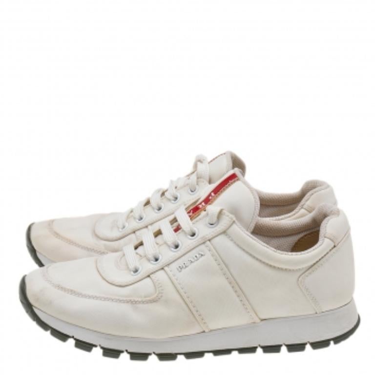 Built to last and add style to any outfit, these chic white sneakers from Prada Sport are all you need. The low-top pair has lace-ups on the vamps and sturdy rubber soles that lend ultimate comfort for everyday use.