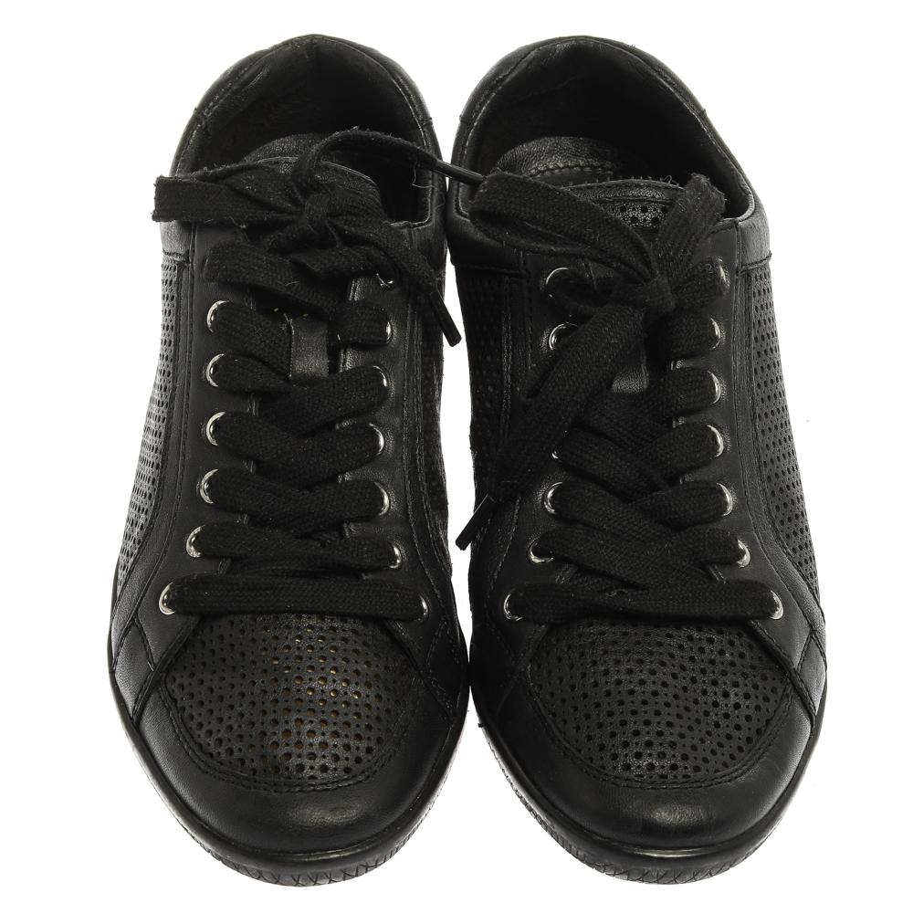 These Prada Sports low top sneakers are the embodiment of style and comfort. Rendered in a classic black color and crafted with perforated leather, these impressive sneakers are accented with lace-ups and the brand label on the tongue. They are also