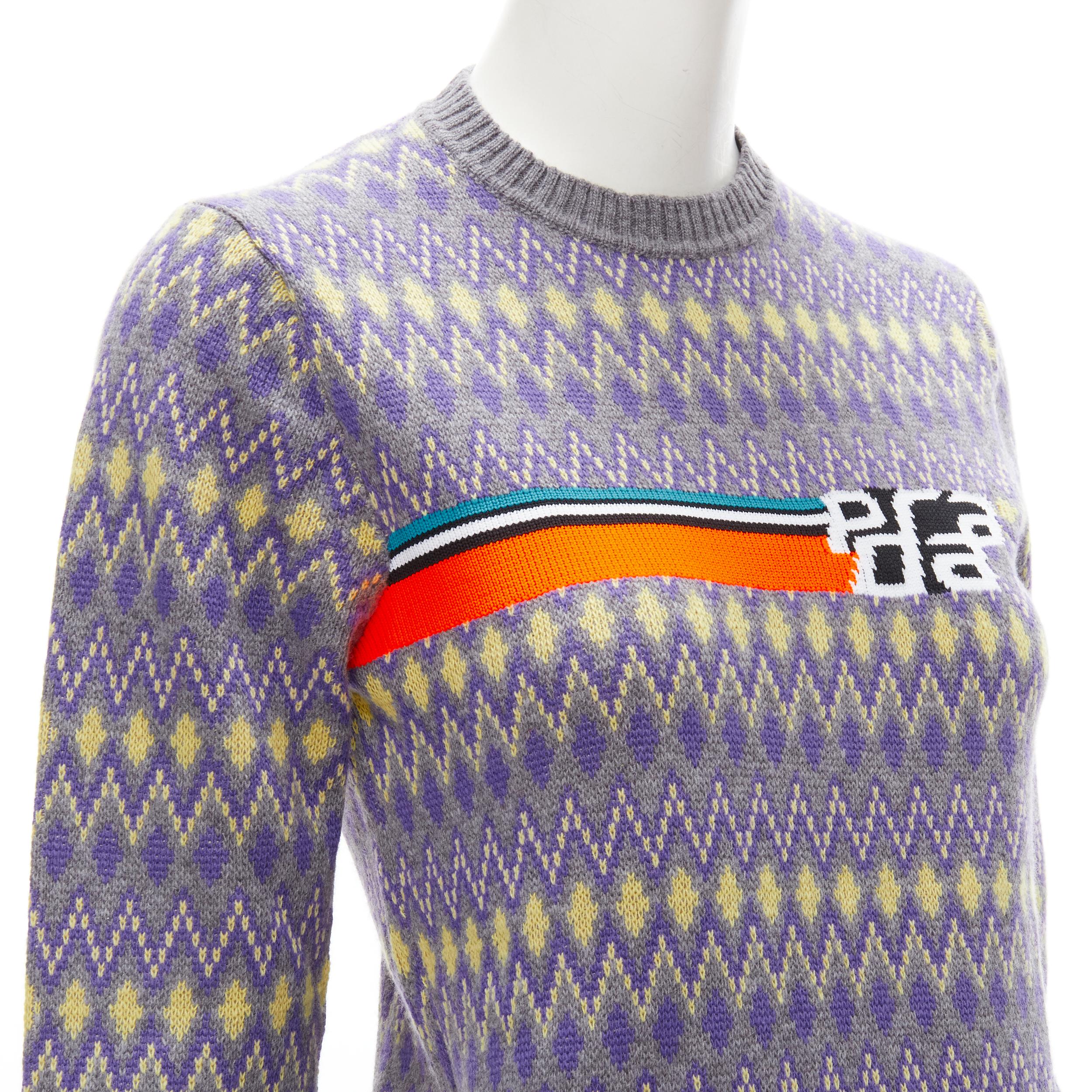 PRADA Sports Logo grey purple argyle knitted sweater S 
Reference: ANWU/A00708 
Brand: Prada 
Designer: Miuccia Prada 
Material: Feels like wool 
Color: Purple 
Pattern: Geometric 
Extra Detail: Neon orange intarsia logo knit at chest. Grey, purple,