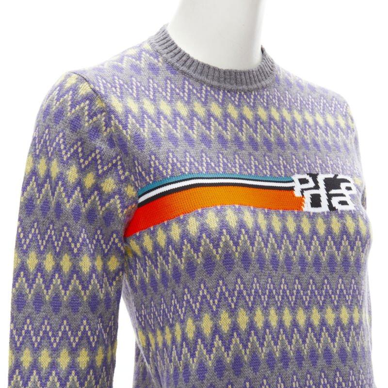 PRADA Sports Logo grey purple argyle knitted sweater S
Reference: ANWU/A00708
Brand: Prada
Designer: Miuccia Prada
Material: Feels like wool
Color: Purple, Yellow
Pattern: Geometric
Extra Details: Neon orange intarsia logo knit at chest. Grey,