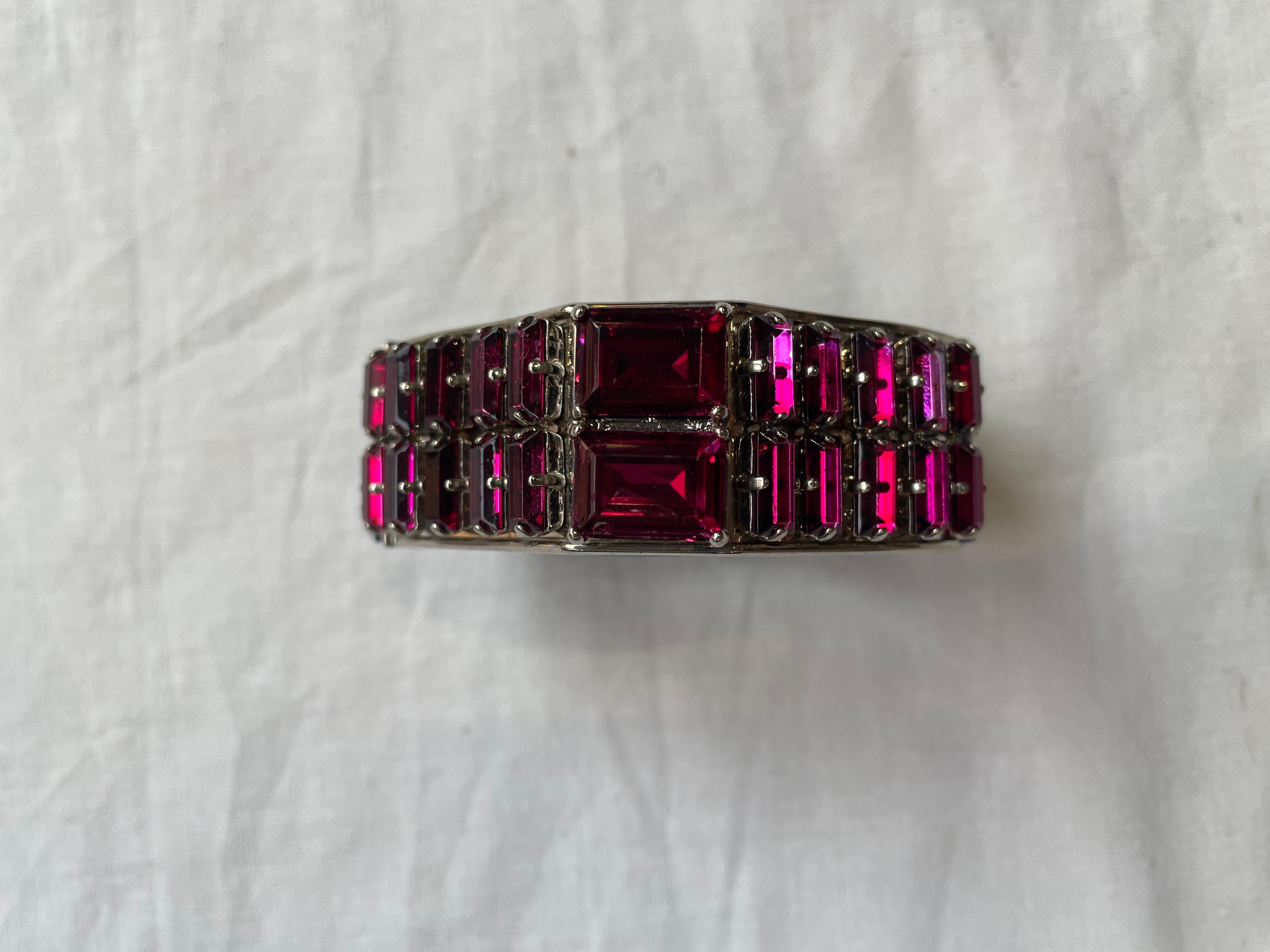 Prada spring summer 2014 bracelet, collection inspired by the high jewelery of the 1940s.
In blue saffiano leather on the outside and green on the inside with fuchsia-colored semiprecious stones. 
Interlocking side opening. 
It shows some signs of