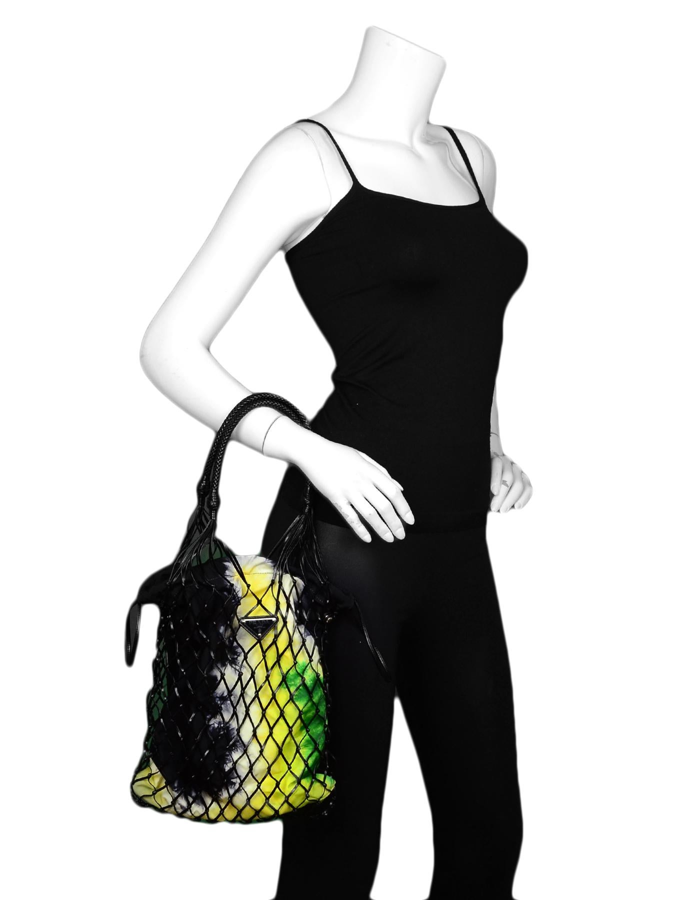 Prada Spring/Summer 2019 Leather Mesh Bag w/ Canvas Tie-Dye

Made In: Italy
Year of Production: 2019
Color: Black, white, yellow, green
Hardware: Silvertone
Materials: Leather, fabric
Lining: Canvas
Closure/Opening: Drawstring
Exterior Pockets: