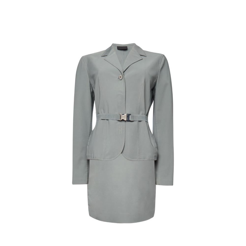 This stunning Prada vintage suit offers a sophisticated and timeless design, showcasing the brand's renowned craftsmanship.
This suit features a structured blazer with a flattering belted waist, perfectly combining classic tailoring with modern