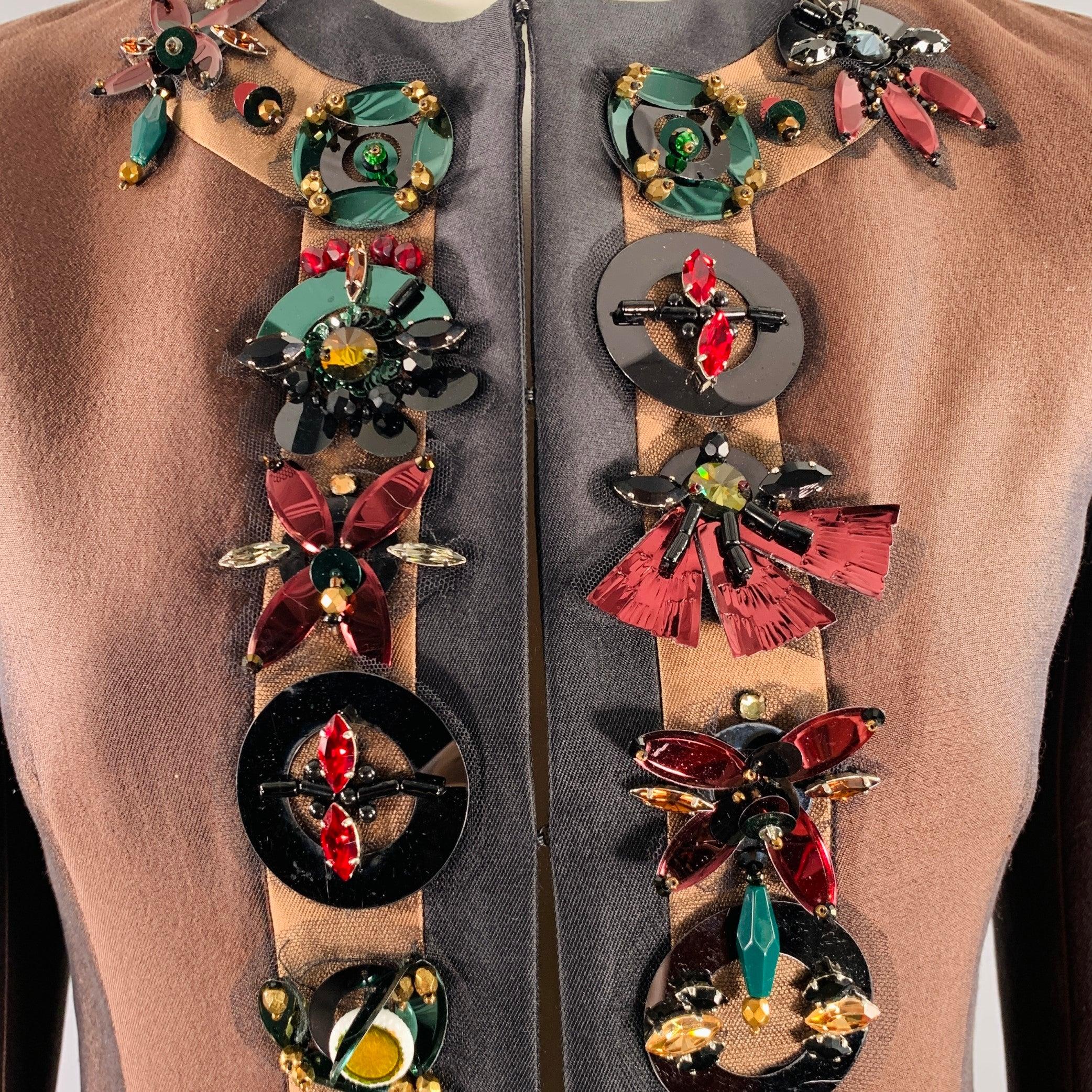 PRADA SS 2005 jacket
in a brown and black wool silk featuring rhinestone embellishment trim, underarm cut outs, and hook & eye closure. Made in Italy.Very Good Pre-Owned Condition. Minor signs of wear. 

Marked:   IT 38 

Measurements: 
 
Shoulder: