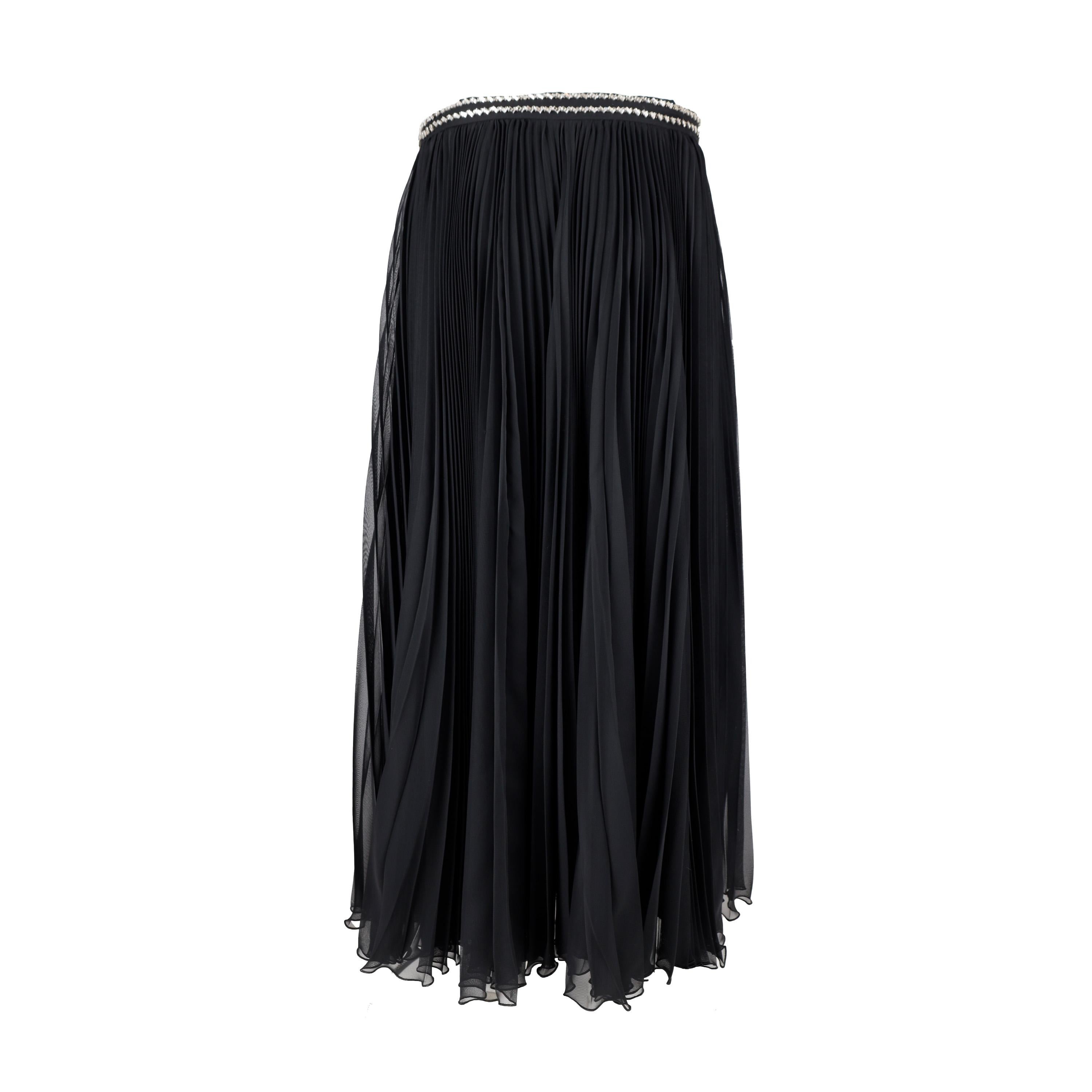 This Prada pleated skirt takes classic sophistication up a notch. Crafted in black fabric, it features two lines of delicate sparkling stones arranged at the waistband and sharp accordion pleats for a midi length finish. 

Remarks: There are some