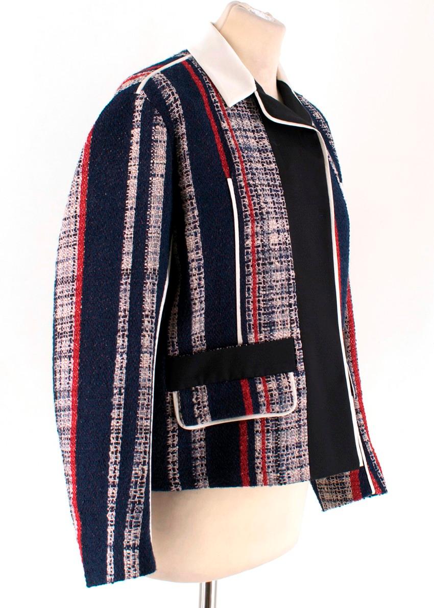 Prada Striped Tweed Jacket

- Tweed jacket crafted in a blend of wool, cotton and silk
- Striped patterning in shades of blue, red and white
- Black silk-blend lining
- White silk & wool-blend collar and trim piping
- Front flap pockets
- Long