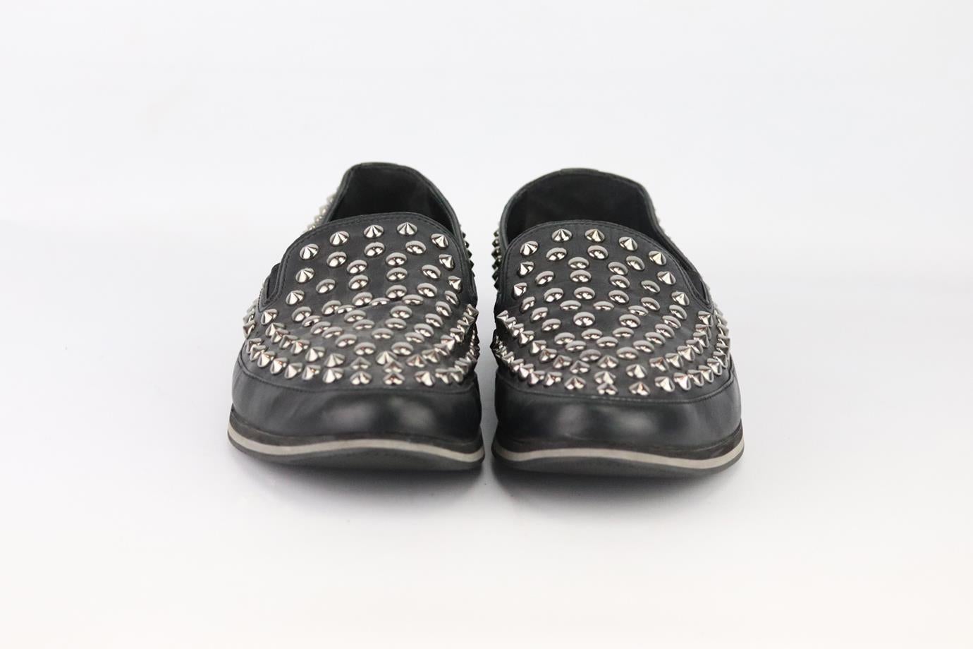 Prada studded leather slip on loafers. Made from black leather and finished with silver-tone spike detail. Black. Slip on. Does not come with box or dustbag. Size: EU 43.5 (US 9.5, UK 10.5). Insole: 11 in. Heel: 0.6 in
