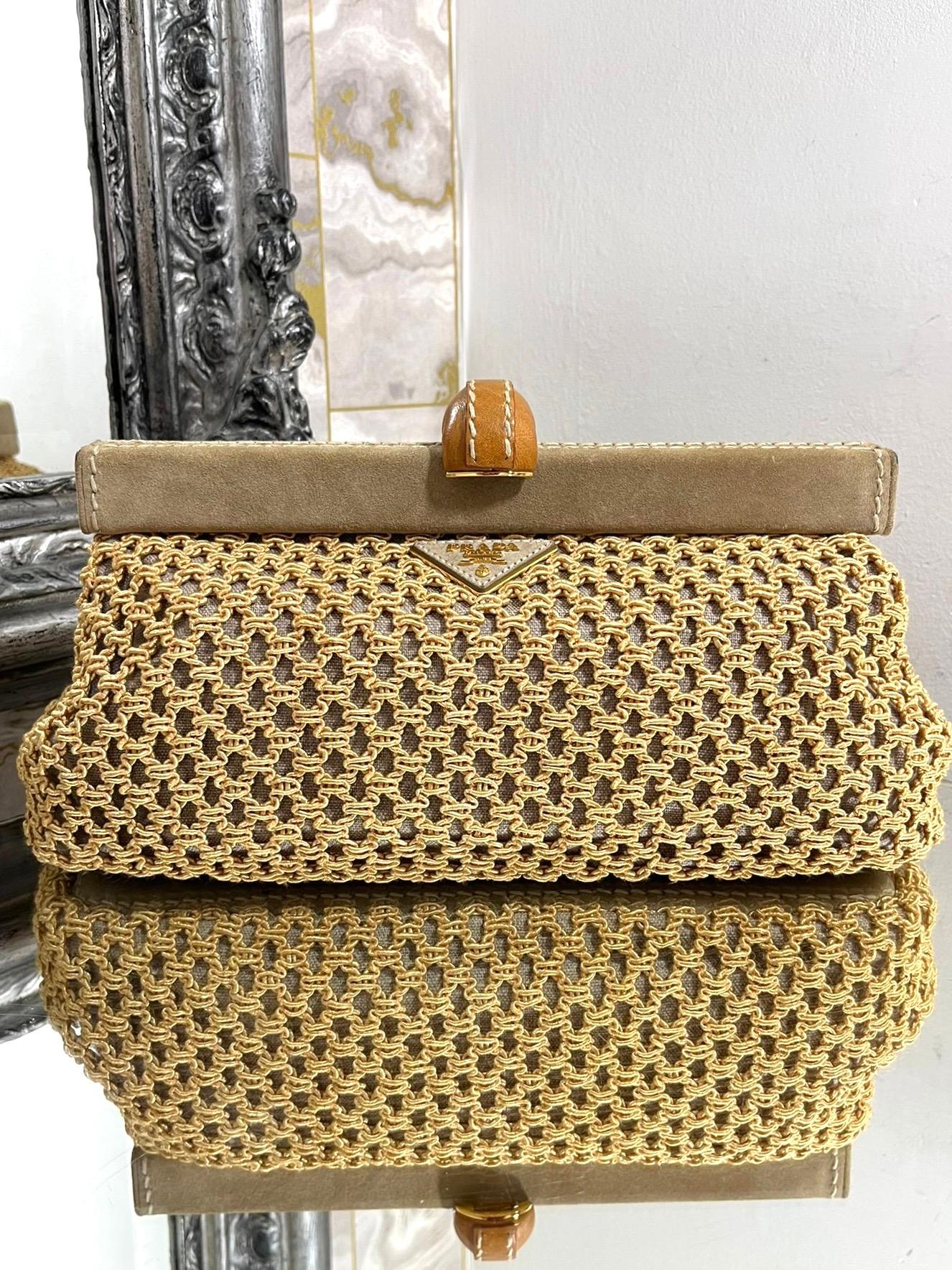 Prada Suede & Raffia Clutch Bag

Beige woven pouch bag with signature logo triangle having the 'PRADA' logo in 

gold metal lettering. Suede trim with fold over leather closure.

Size - Height 16cm, Width 30cm, Depth 10cm

Condition - Good (Some