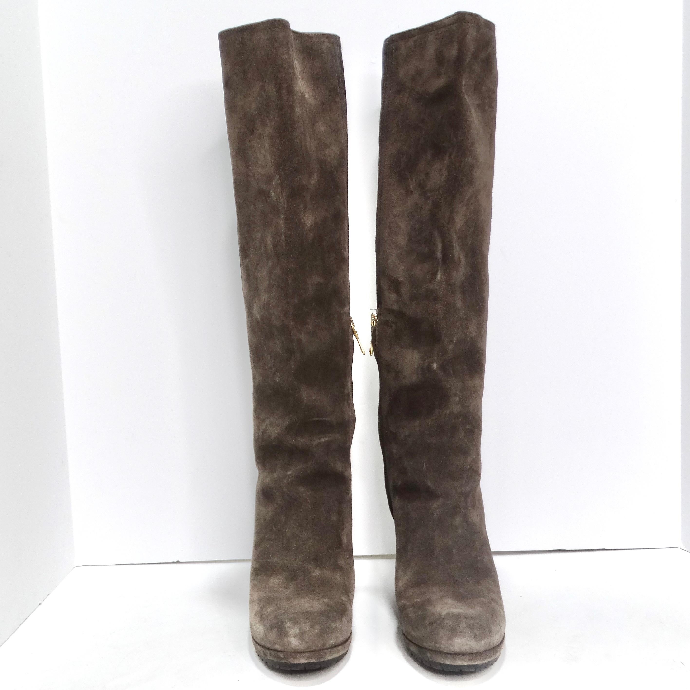 Introducing the Prada Suede Wedge Boots, a luxurious and versatile addition to your footwear collection. These knee-high boots in rich brown suede are not just a fashion statement but also a symbol of comfort and style. The wedge heel provides a