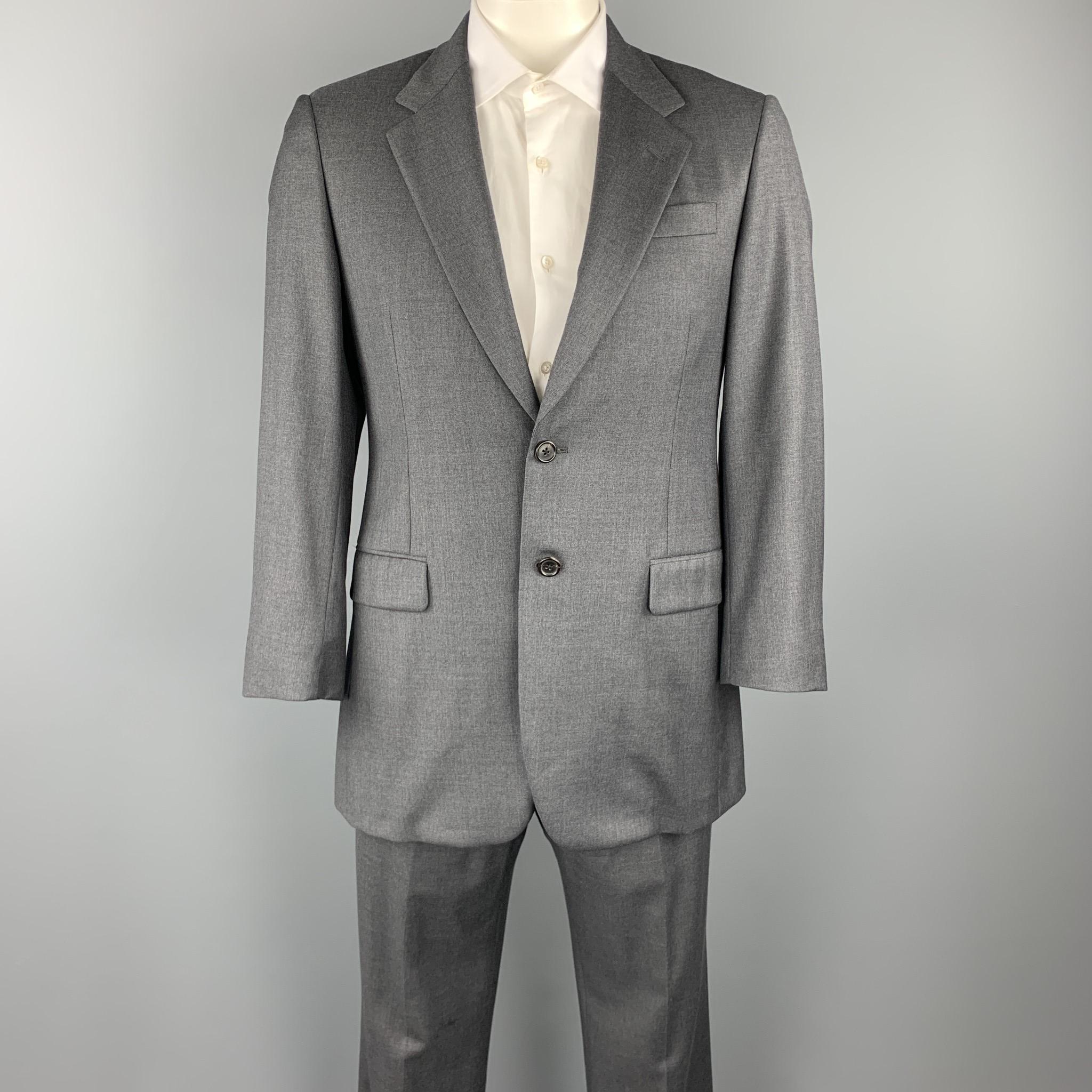 PRADA suit comes in a gray wool with a black rayon liner and includes a single breasted, two button sport coat with a notch lapel and matching flat front trousers. As-Is. Minor damage on lining. Made in Italy.

Very Good Pre-Owned Condition.
Marked: