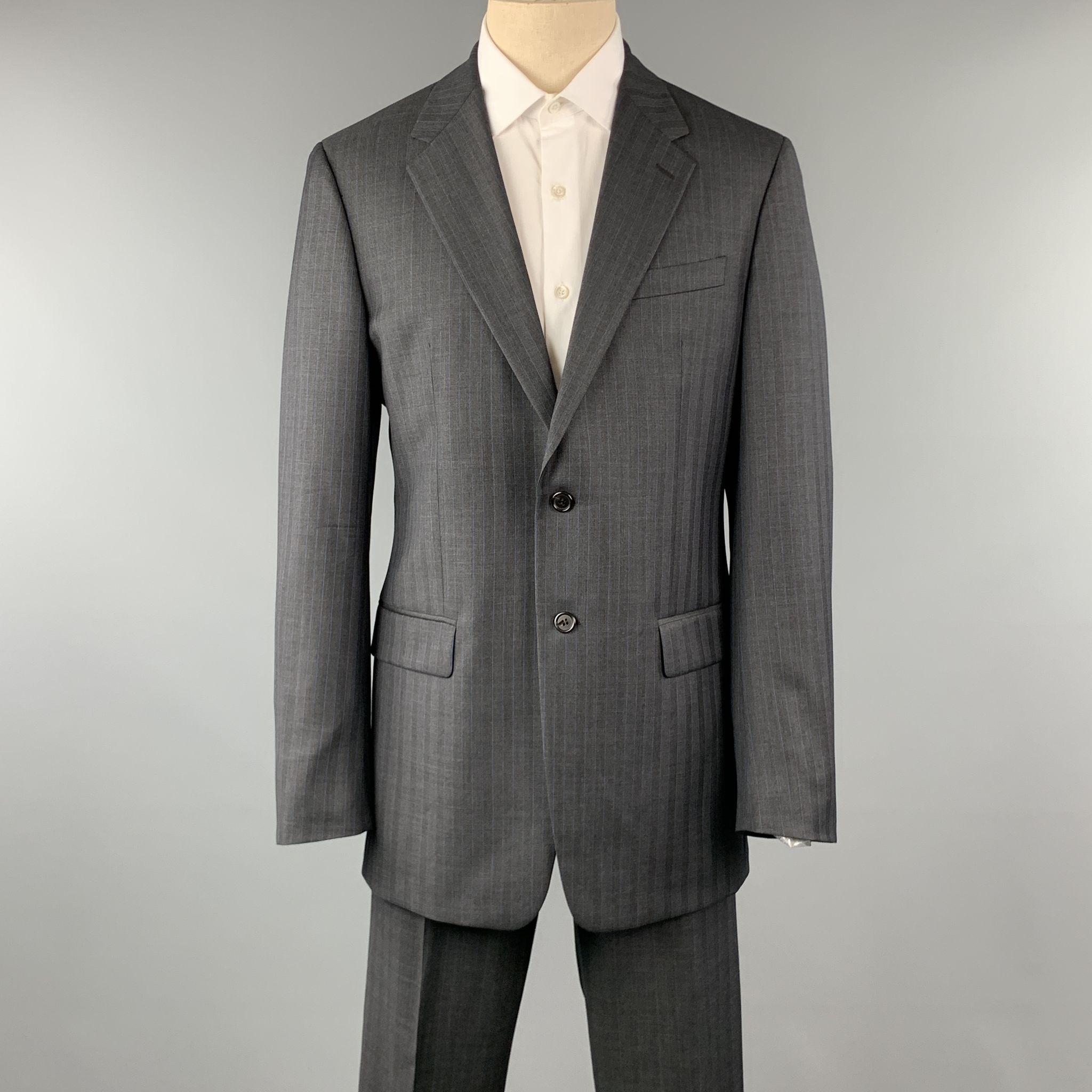 PRADA suit comes in a charcoal stripe wool and includes a single breasted, two button sport coat with notch lapel and matching front trousers. Made in Italy.

Pre-Owned Condition.
Marked: 52 L

Measurements:

-Jacket
Shoulder: 19 in. 
Chest: 42 in.