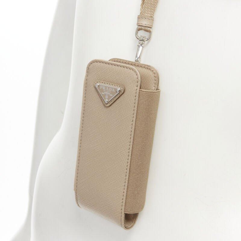 PRADA Symbole Triangle logo saffiano leather Phone lanyard bag beige nude
Reference: TGAS/C01577
Brand: Prada
Designer: Miuccia Prada
Model: Phone pouch
Material: Leather, Nylon
Color: Beige
Pattern: Solid
Closure: Elasticated
Extra Details: This