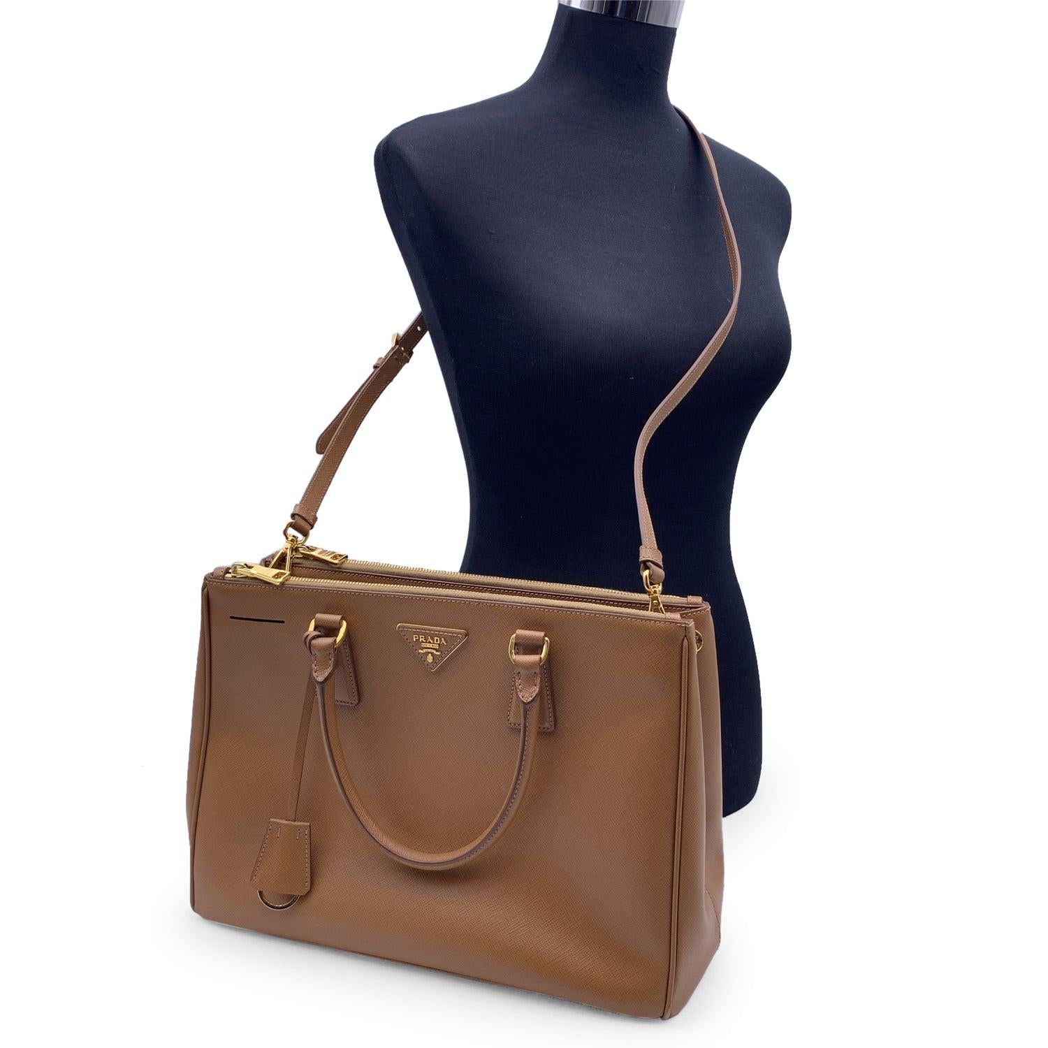 Stunning PRADA top handles bag/handbag mod. 'Galleria', designed in different shades of tan Saffiano leather and finished with leather triangle logo on the front, all in a structured tote silhouette. It features double round top handles and