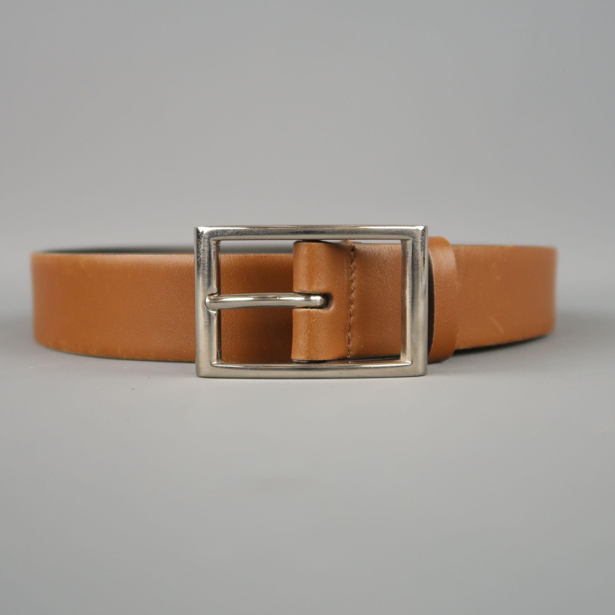 PRADA dress belt features a tan brown leather strap with a  silver tone metal rectangular buckle. Minor wear. Made in Italy.

Good Pre-Owned Condition.
Marked: 75 / 30

Length: 35.5 in.
Width: 1 in.
Fits: 27-31 in.
