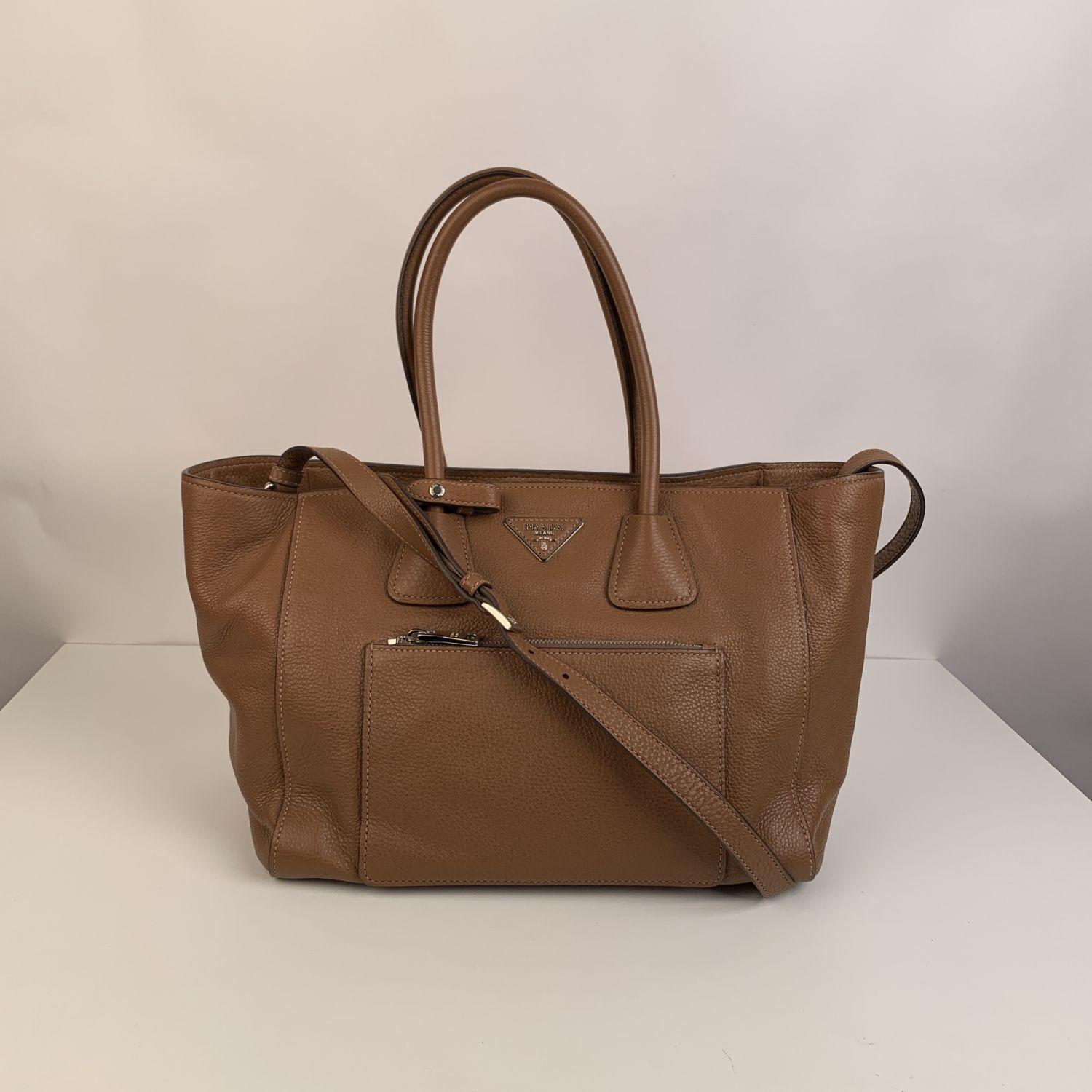 PRADA Vitello Phenix leather tote bag. Mod. BN2795. Tan color (official Prada color is 'Cannella') Simple and clean design. It features center snap button closure, front zip pocket, double rolled handles and a long flat adjustable and removable