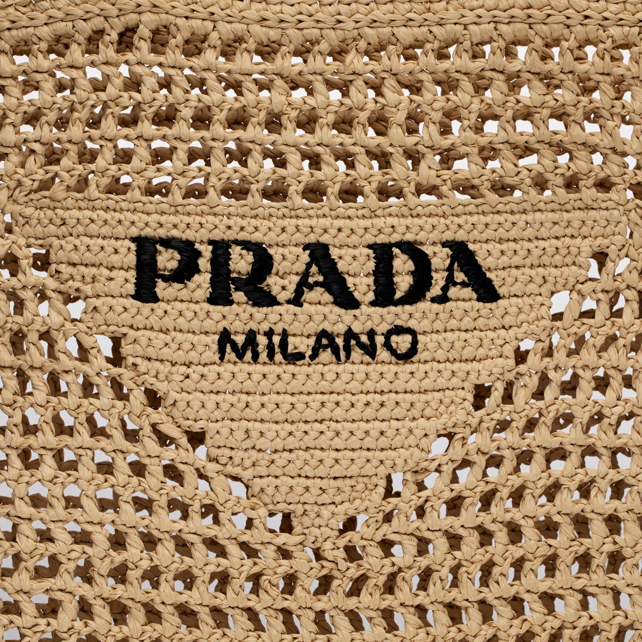 Brand: Prada
Product: Raffia Tote Bag
Size: L 36 X H 38 X D 3 Cm
Colour: Tan
Material: Raffia

Condition:

Pristine: The product is in pristine condition, without any signs of wear or damage. It appears unused and in original condition.

Accompanied