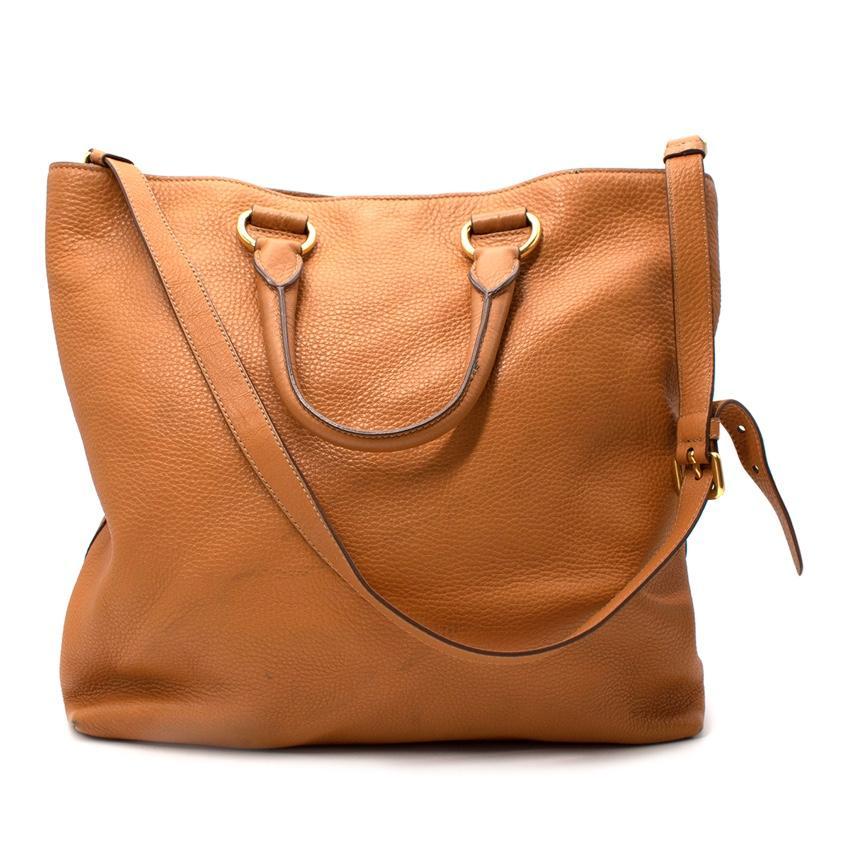 Prada Tan Leather Soft Body Tote Bag

- Grained calf leather
- Multi-pocket, satin-lined interior
- Two top handles with a detachable and adjustable shoulder strap
- Gold-tone metal hardware, with logo detail on the front
- Detachable ID