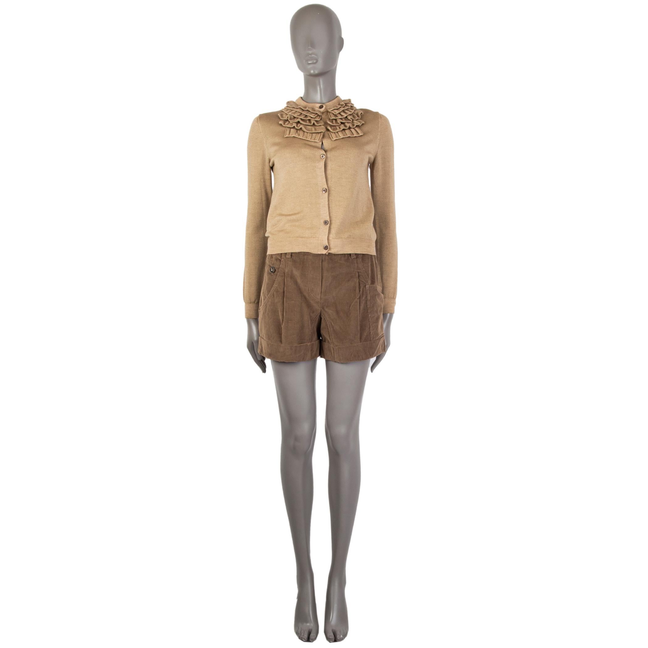 100% authentic Prada short cardigan in tan wool (70%) and silk (30%). With crew neck and ruffled details. Closes with fawn buttons on the front. Has been worn and is in excellent condition. 

Measurements
Tag Size	40
Size	S
Shoulder Width	36cm