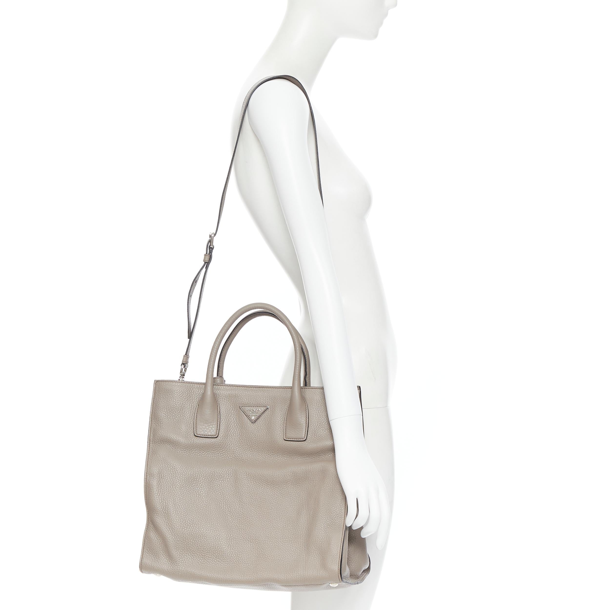 PRADA taupe grey grained leather triangle logo crossbody strap small tote bag 
Reference: PYCN/A00078 
Brand: Prada 
Designer: Miuccia Prada 
Model: Leather tote 
Material: Leather 
Color: Grey 
Pattern: Solid 
Closure: Zip 
Extra Detail: Grainy
