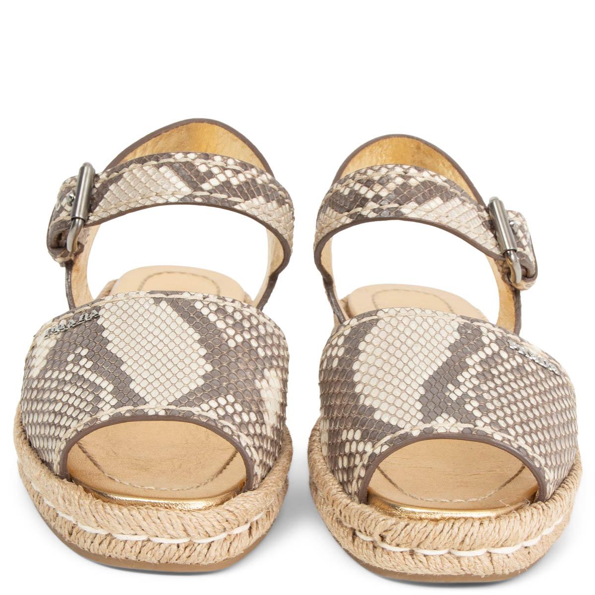 100% authentic Prada raffia flat sandals in sand and grey python with a beige sole. Have been worn once or twice and are in excellent condition.

Measurements
Imprinted Size	36.5
Shoe Size	36.5
Inside Sole	23cm (9in)
Width	7.5cm