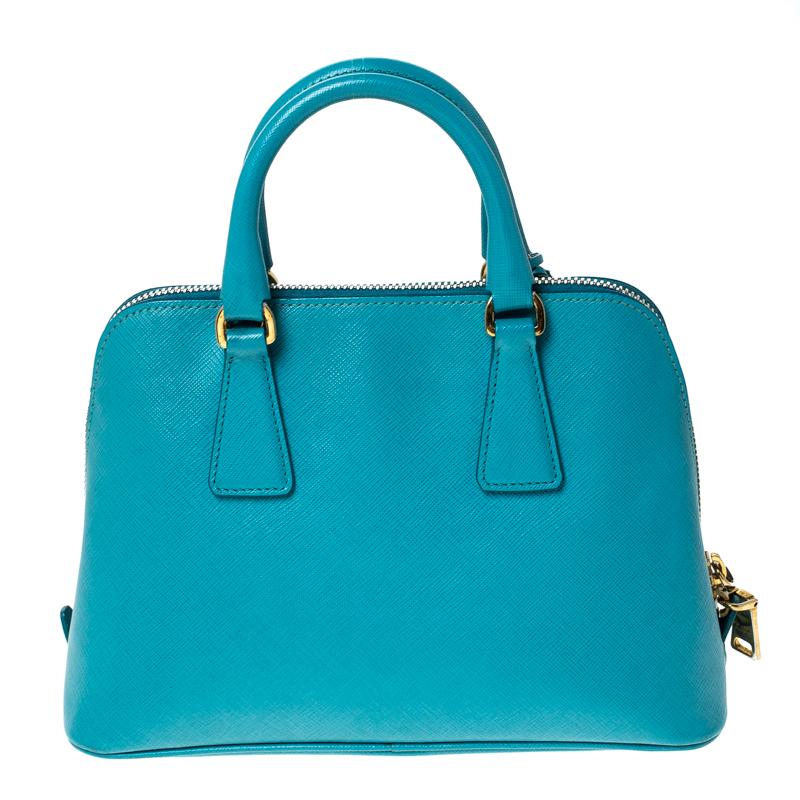This stunning Promenade satchel is high on appeal and style. Dazzling in a classy teal shade, the bag is crafted from leather and features two rolled handles. The zip closure leads way to a nylon interior with enough space for your essentials and