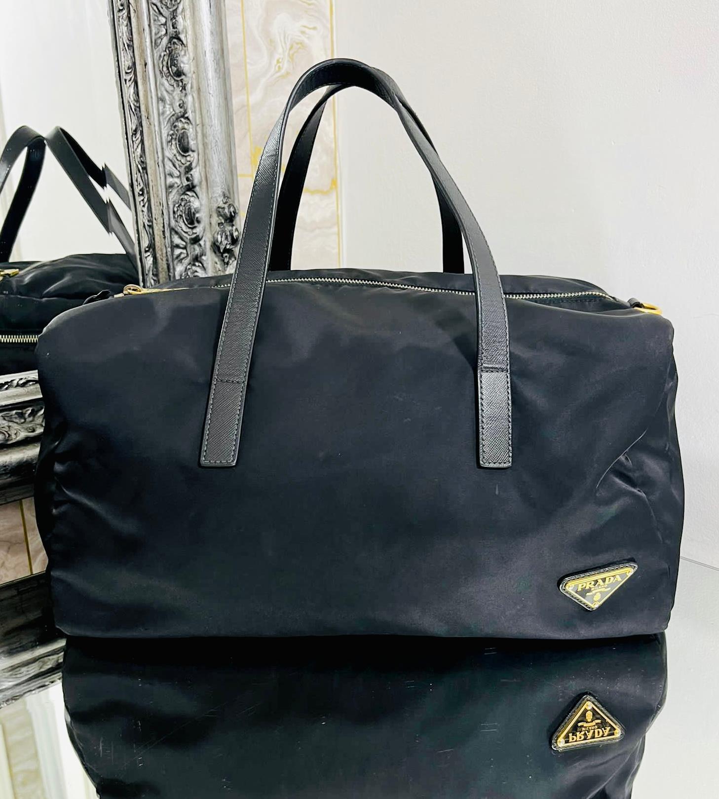 Prada Tessuto Boston Bag

Black duffle style handbag detailed with 'Prada' logo plaque to the side.

Featuring dual leather handles and top zip closure.

Designed with spacious interior with zipped pocket.

Size – Height 29cm, Width 35cm, Depth