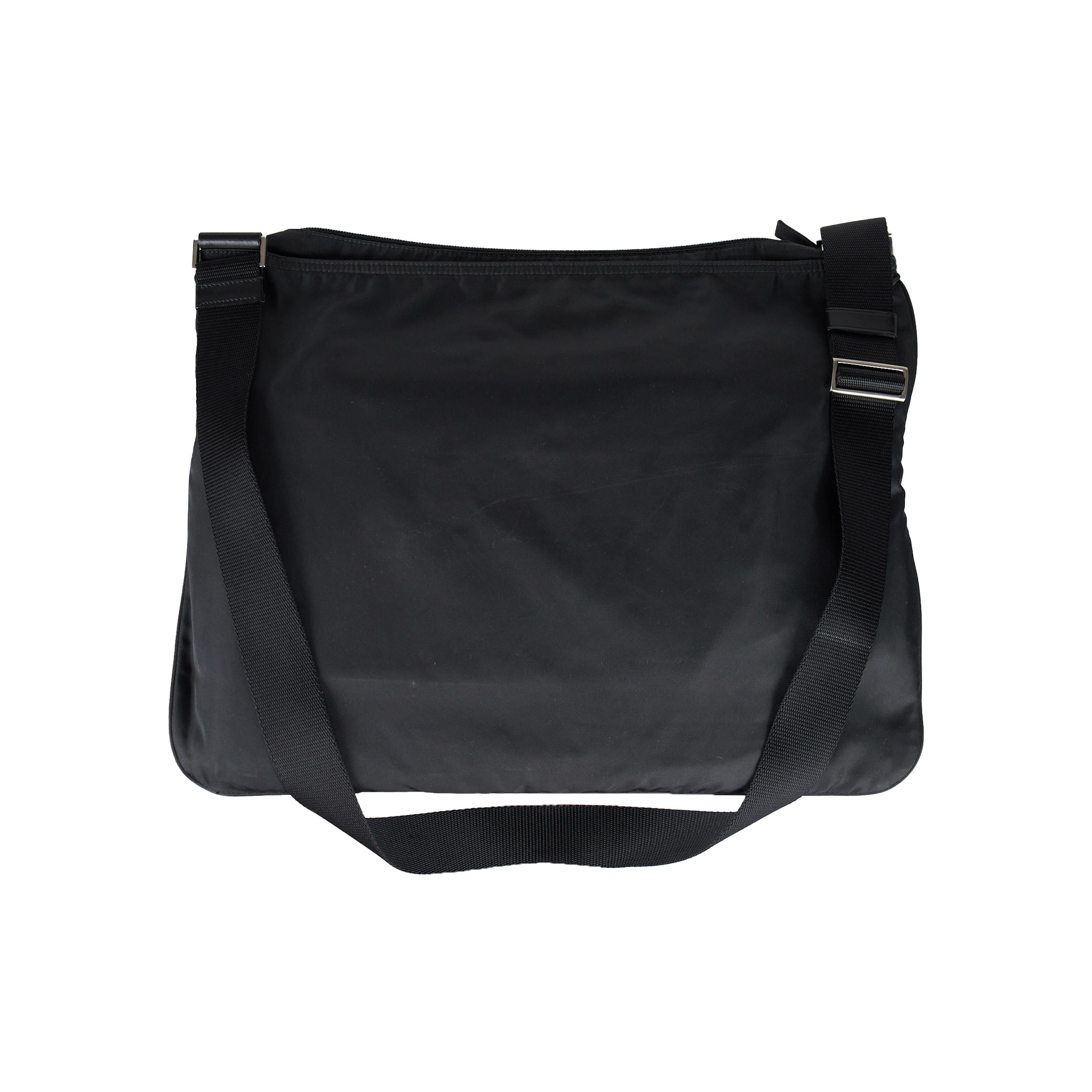 This Prada Tessuto Crossbody Bag is created with a fabric exterior, silver-tone hardware, and a logo plaque for a sophisticated finish. It features a single adjustable shoulder strap, signature logo interlining, and an interior pocket with logo