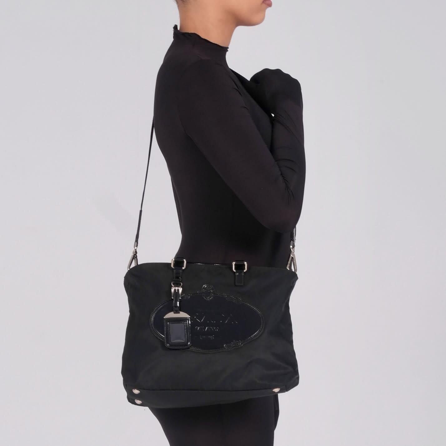 Color: Black
Material: nylon with leather details
Comes with: shoulder strap and dust bag
Condition: Very good. Light residue and faint marks.
Made in Italy

Measurements~
Height 9”
Width 11”
Depth 4”
Drop 3.5”