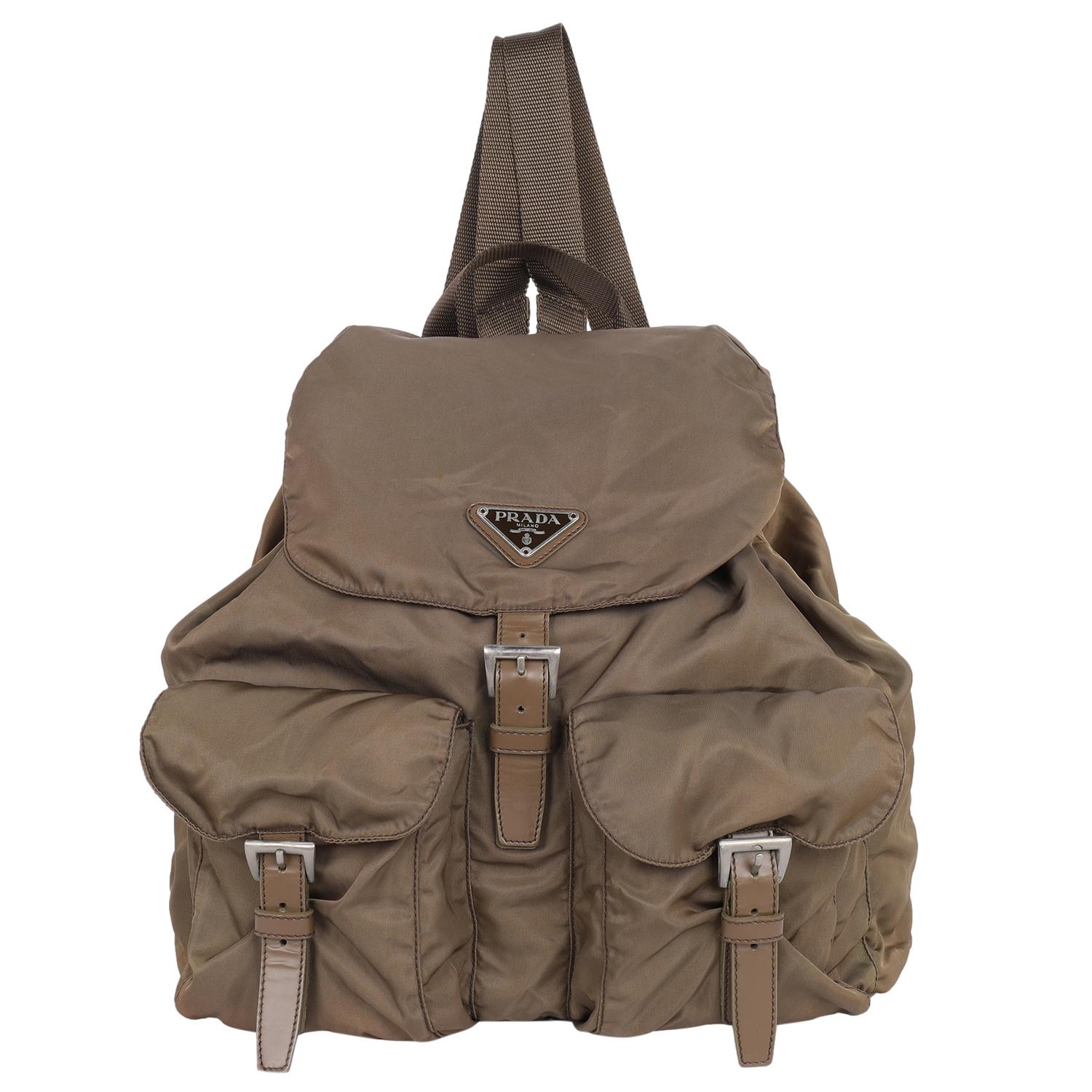 Authentic, pre-loved Prada Tessuto brown nylon drawstring backpack. This backpack features a nylon body, drawstring and buckle closure, flat back straps, drawstring closure, and exterior buckle pockets.

Made in Italy

11.5