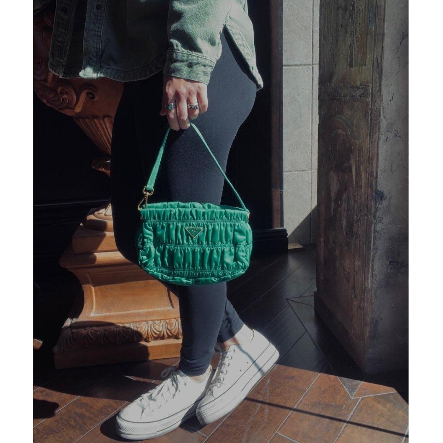 Prada Tessuto Nylon Gaufre Shoulder Bag in Mint Green. This petite Prada handbag is crafted of pleated tessuto nylon in green with gold hardware. The bag features a looping leather shoulder strap and the top zipper opens to a green Prada logo