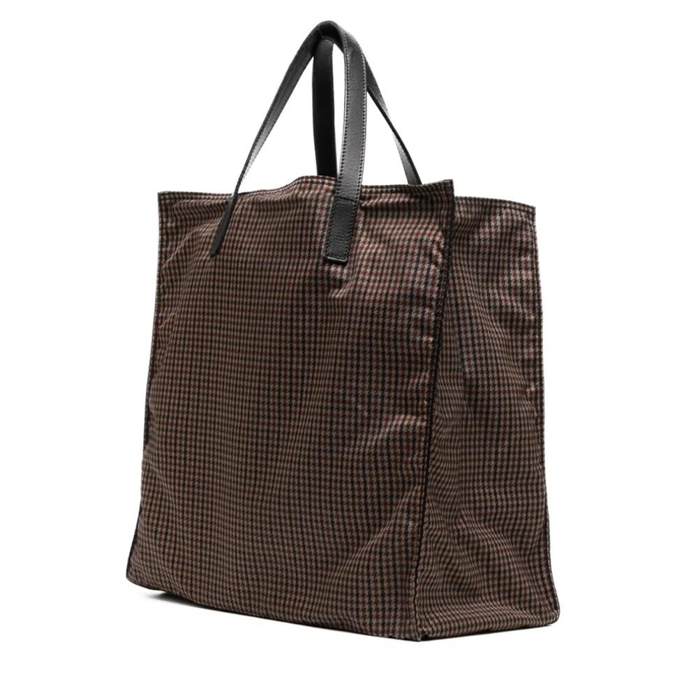 This Prada Tessuto Stampato Houndstooth Tote Bag is a stylish and practical accessory. Crafted with a houndstooth pattern, the tote features a leather trim, enamel triangle logo and silver-tone hardware. The bag has two top handles and an open top