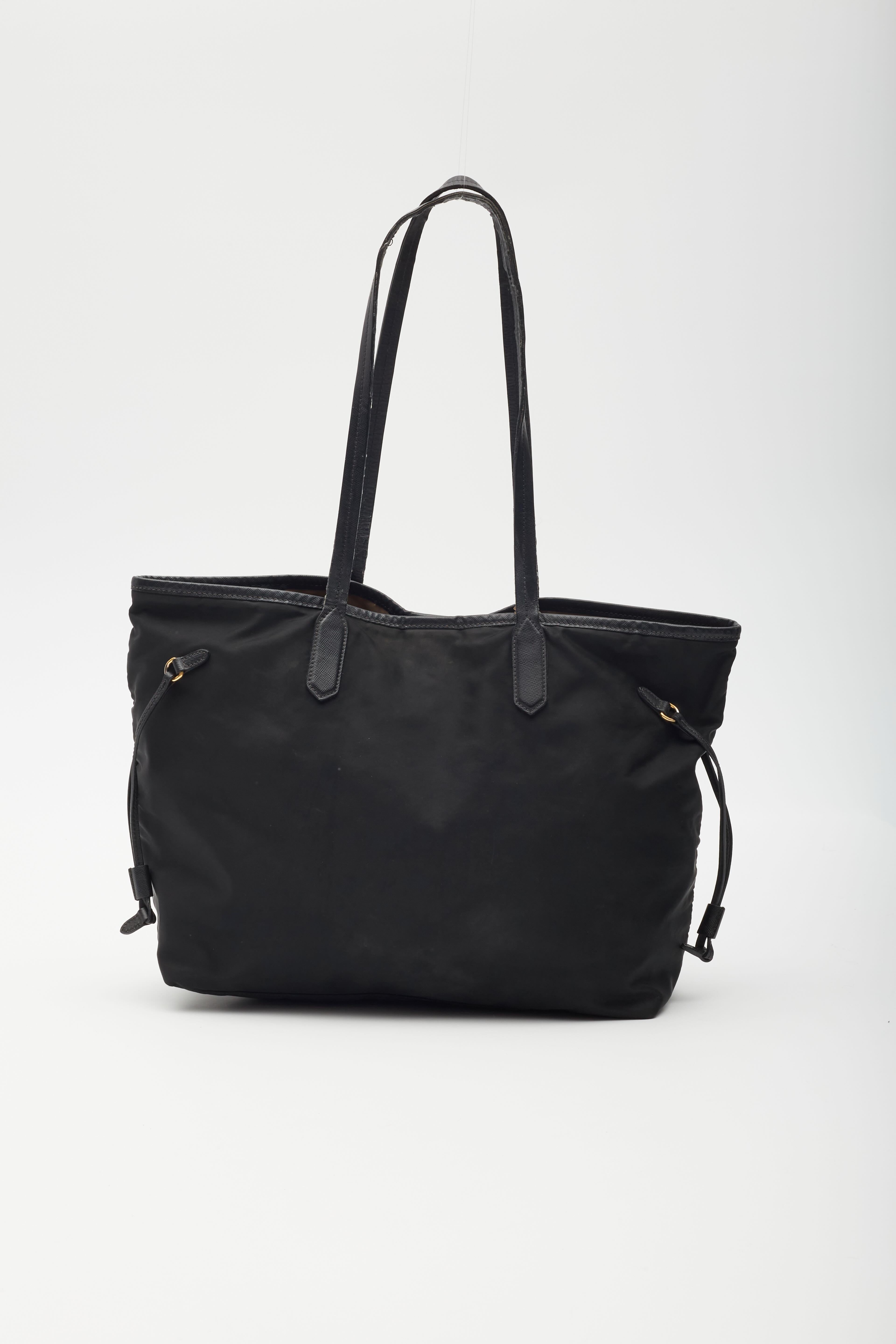 Color: Black
Material: Nylon
Condition: Good. faint hairline marks throughout. Light scratches and wrinkles.
Made in Italy

Measurements~
Height 10”
Length 10”
Depth 5”
Drop: 10”

Vintage,