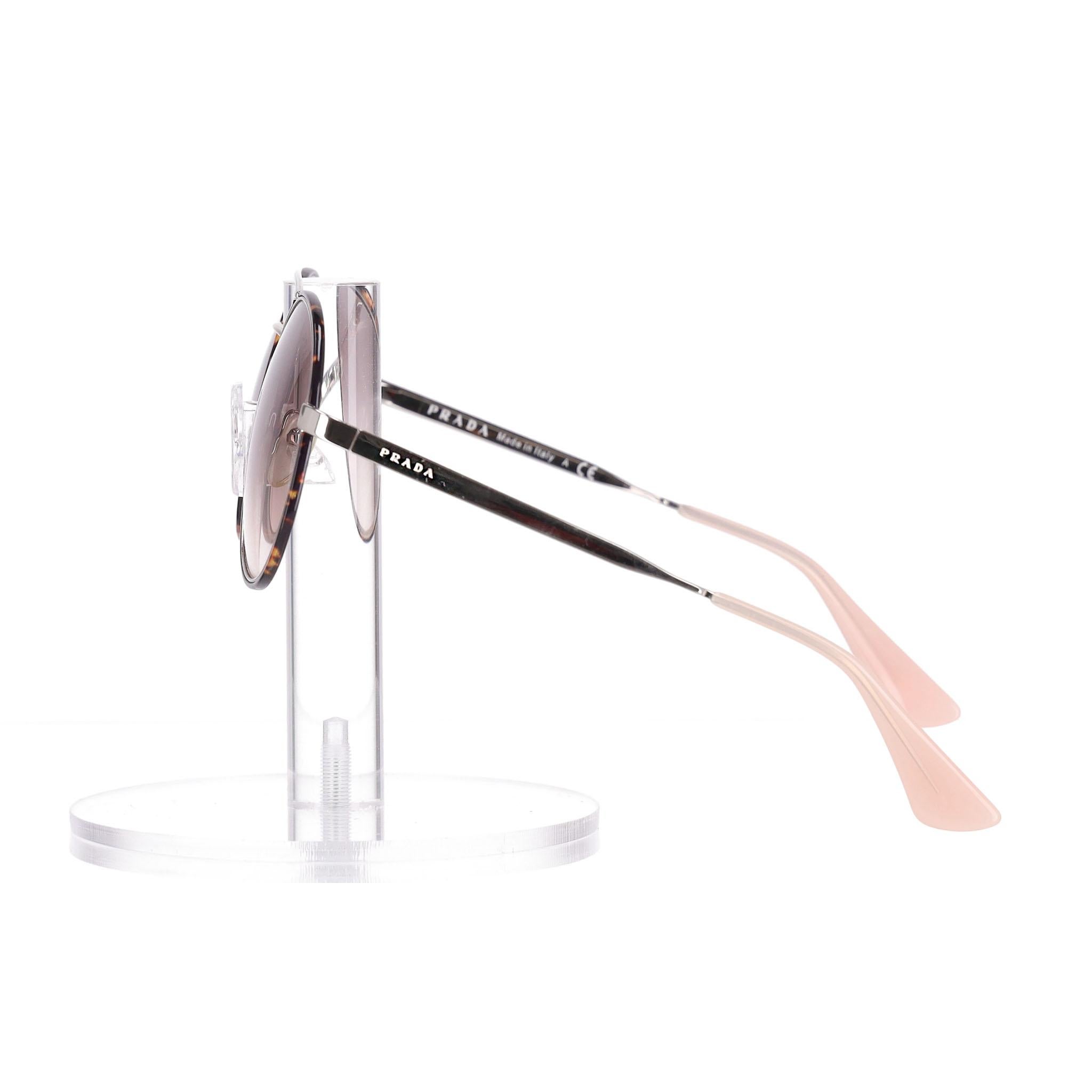 Prada Tortoiseshell Round Sunglasses

Round sunglasses designed with think tortoiseshell frames and light gradient lenses.

Double-bridge design and think silver metal arms detailed with 'Prada' engravement and finished with light pink temple