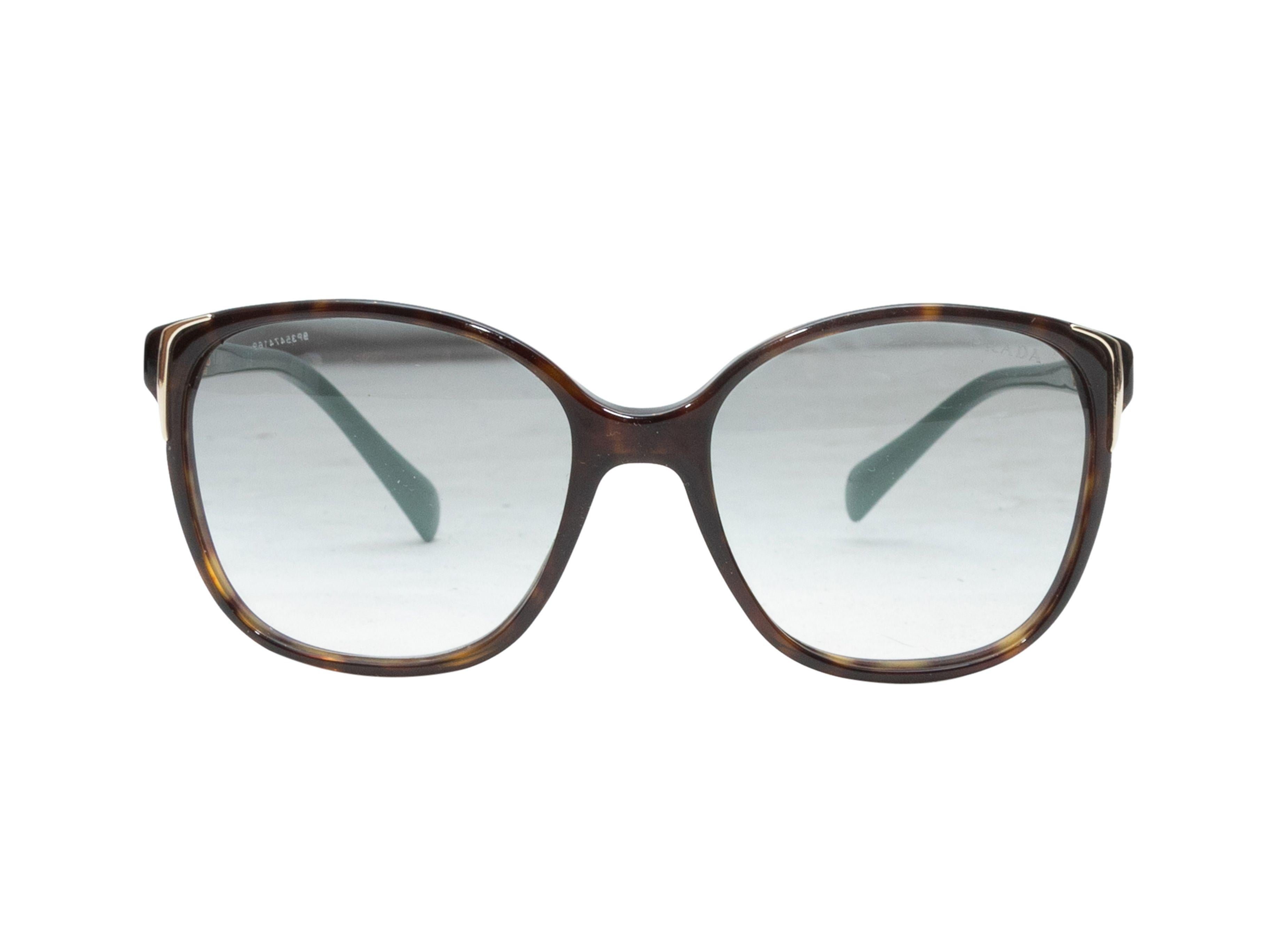 Product Details: Tortoiseshell and teal acetate sunglasses by Prada. Teal tinted lenses. 5.5