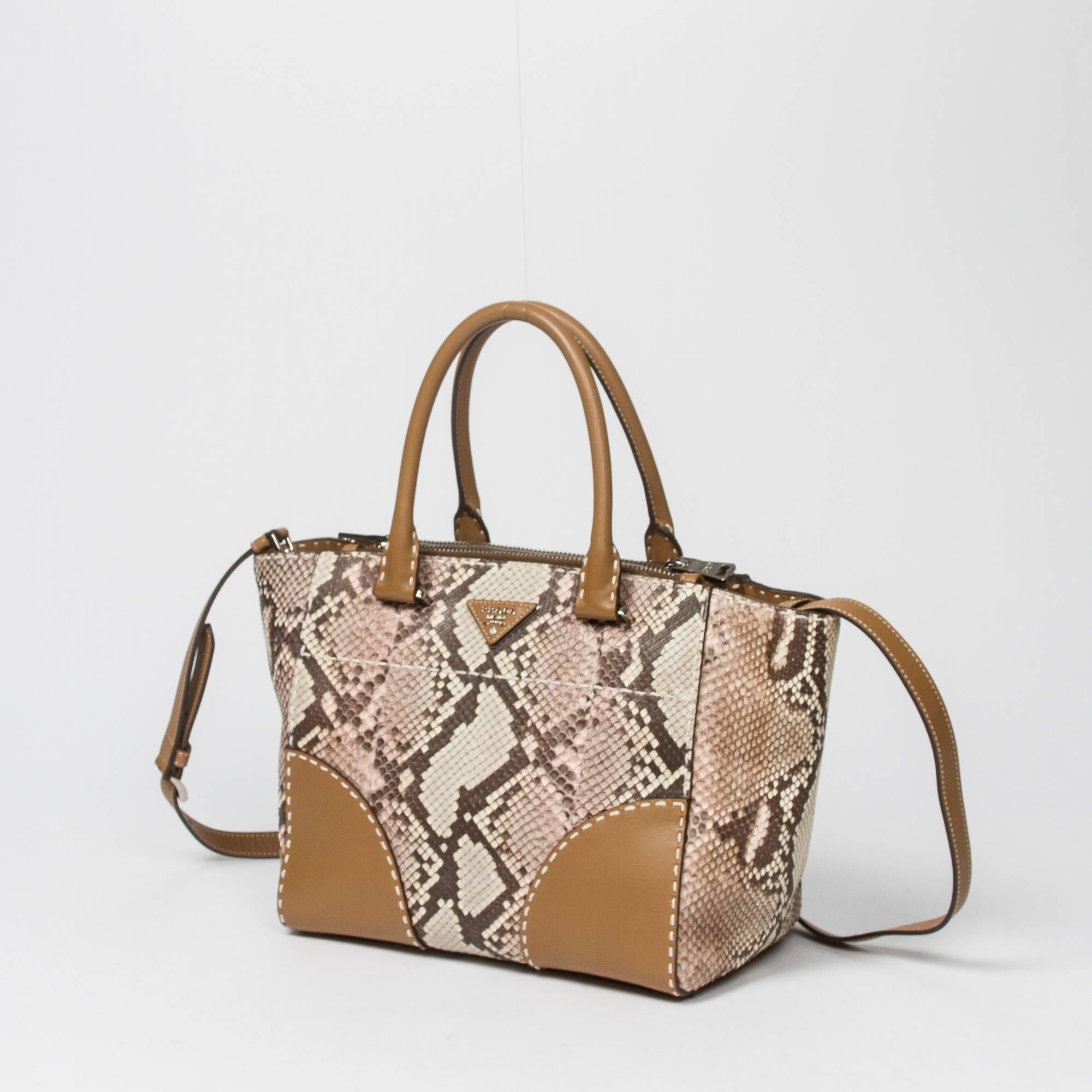 Tote in Beige/Ivory/Brown python leather with light brown leather handles, silver tone hardware. Lined interior very clean. Dustbag included. Production code LN 08650. Very light signs of use. The bag has kept its shape very well. Clean interior. In