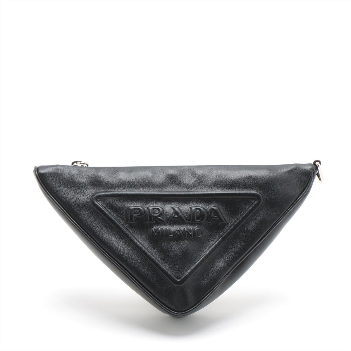 The Prada Triangle Leather Clutch Bag in Black is a sleek and modern accessory that effortlessly combines contemporary design with Prada's timeless elegance. Meticulously crafted, the clutch features a distinctive triangular shape, showcasing the