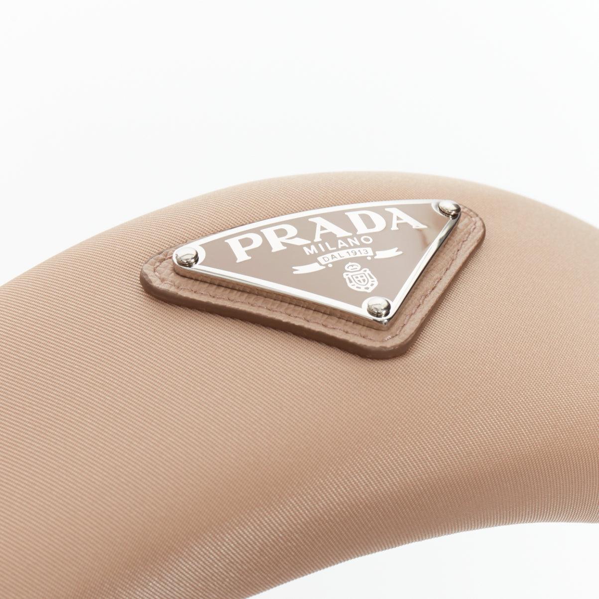 PRADA Triangle Metal Logo beige satin puffy Alice headband
Reference: VACN/A00078
Brand: Prada
Designer: Miuccia Prada
Material: Satin
Color: Nude
Pattern: Solid
Closure: Slip On
Lining: Nude Satin
Extra Details: Prada triangle logo