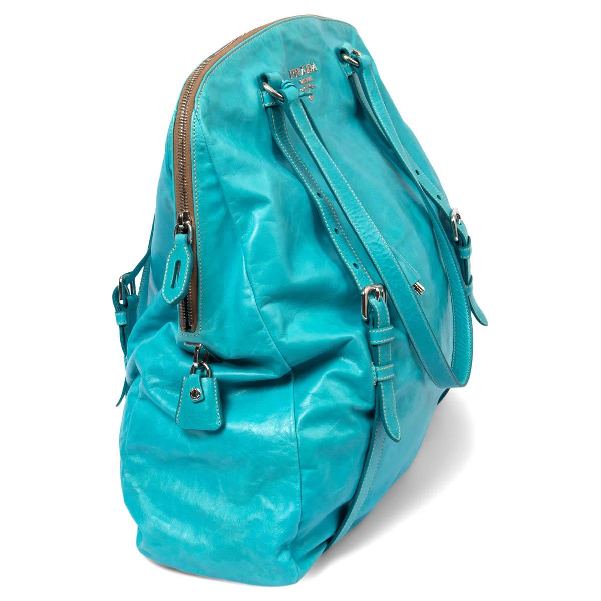 100% authentic Prada 'New Look Bauletto' shoulder bag in turquoise smooth calfskin featuring silver-tone hardware. Opens with a zipper on the top and is lined in turquoise nylon with one zipper pocket against the back and an open pocket against the