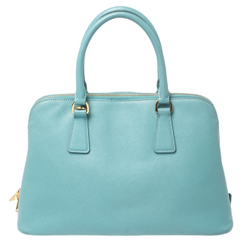 This stunning Promenade tote is high on appeal and style. Dazzling in a classy turquoise shade, the bag is crafted from leather and features two rolled handles. The zip closure leads way to a nylon interior with enough space for your essentials and