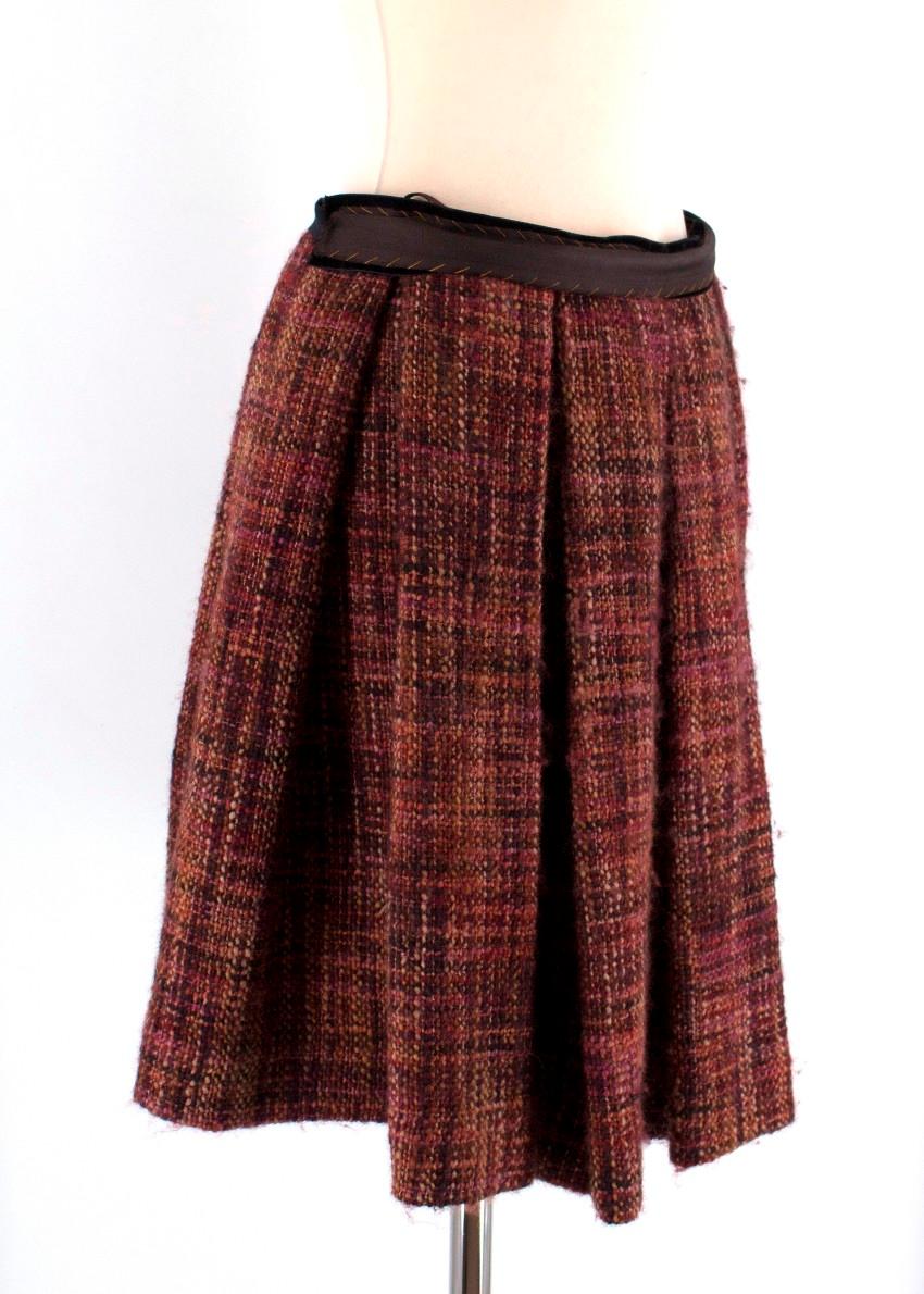 Prada Tweed Pleated Skirt

- Chunky tweed skirt
- Multicoloured in shades of red, pink, orange and burgundy
- Pleated
- Lined
- Popper and hook & eye fastening
- Self-tie bow at rear

Please note, these items are pre-owned and may show some signs of
