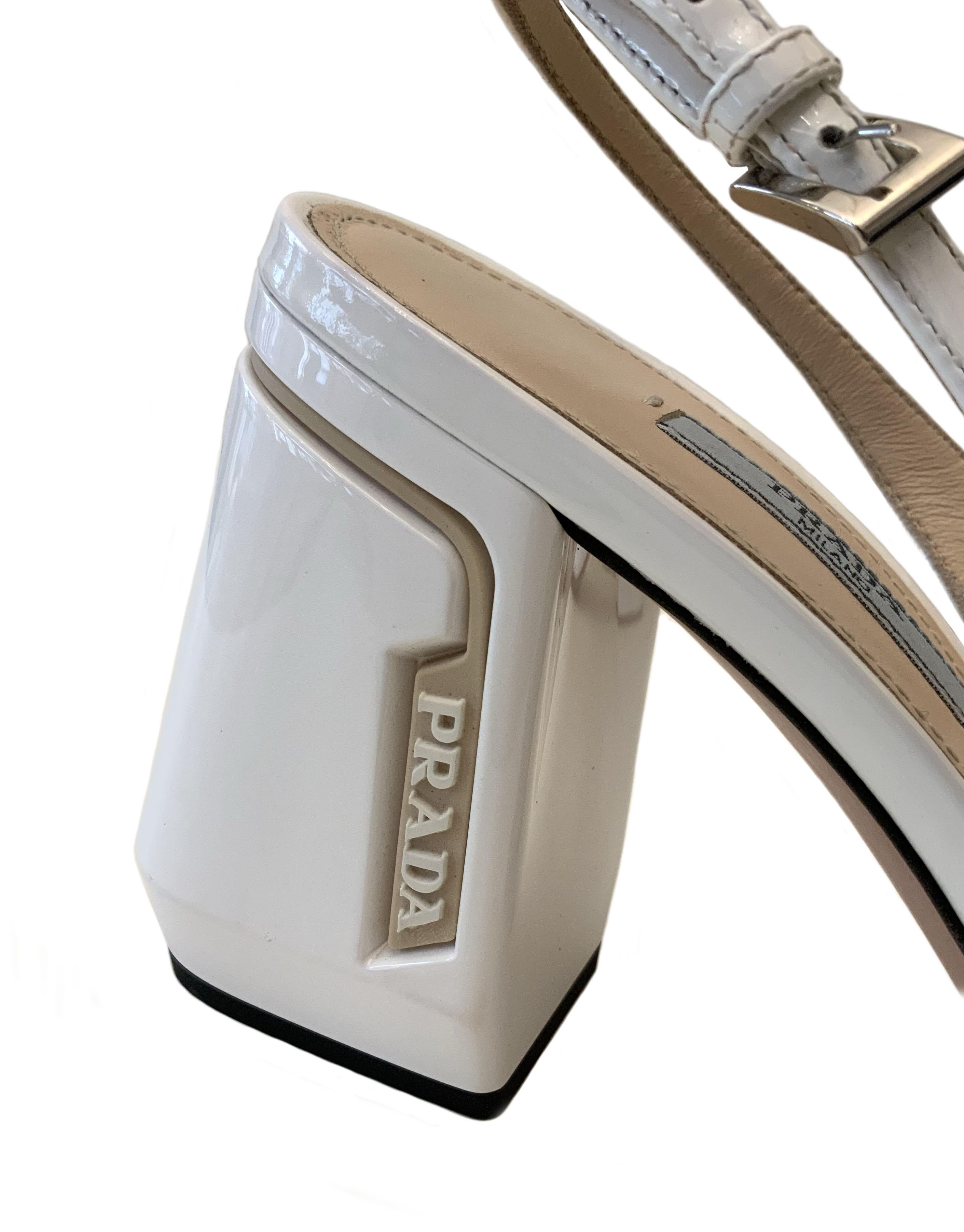 These white and beige patent leather slingback pumps from the house of Prada feature a square toe, a slingback ankle strap, a chunky heel with the embossed logo on the side.

Collection: Spring-Summer 2020
Material: patent leather
Insole and