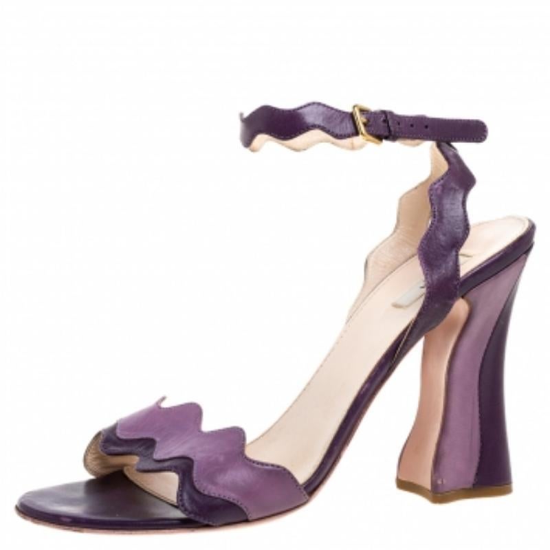 These sandals from Prada are a perfect blend of fashion and comfort! These two-toned purple sandals are crafted from leather and feature an open-toe silhouette with wavy straps. They come equipped with leather-lined insoles, ankle straps, 10.5 cm