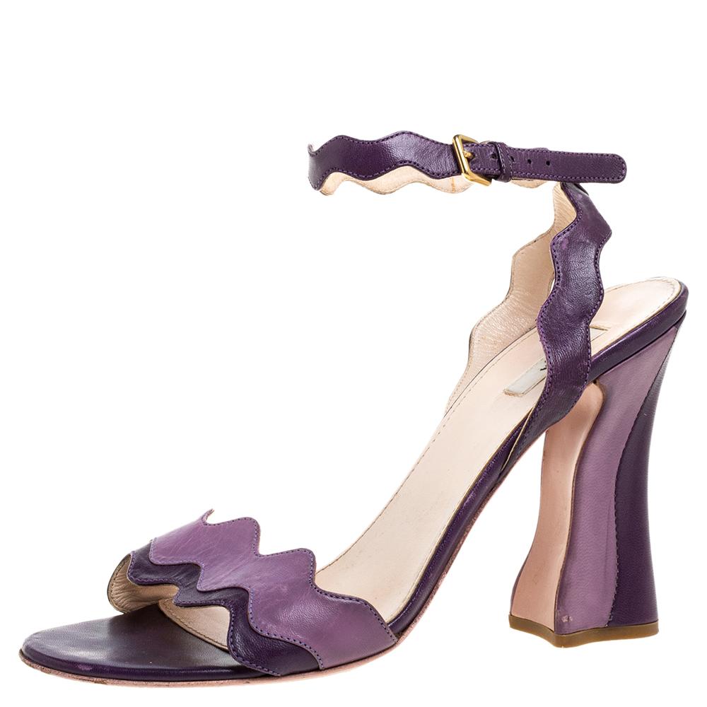 These sandals from Prada are a perfect blend of fashion and comfort! These two-toned purple sandals are crafted from leather and feature an open-toe silhouette with wavy straps. They come equipped with leather-lined insoles, ankle straps, 10.5 cm