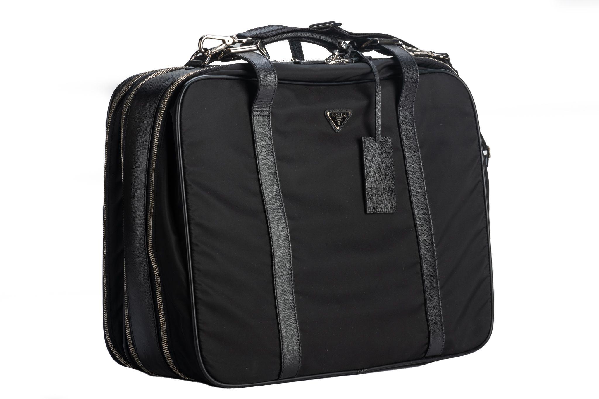 Prada excellent condition black nylon and leather weekender suitcase. Detachable strap. Multiple Compartments.
