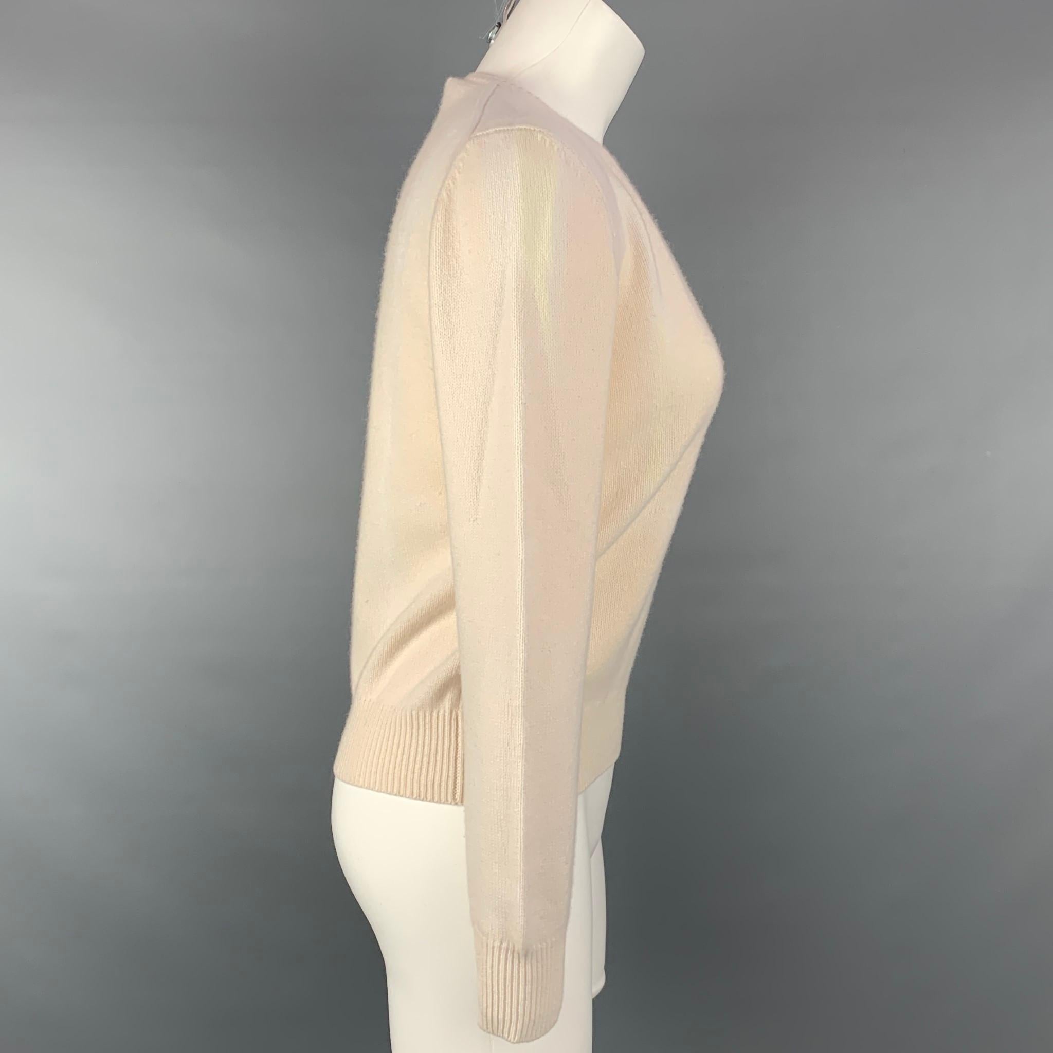 PRADA pullover comes in a cream wool / cashmere featuring a ribbed hem and a v-neck. Made in Italy. 

Good Pre-Owned Condition. Light discoloration at front of sweater.
Marked: 42

Measurements:

Shoulder: 17 in.
Bust: 38 in.
Sleeve: 24.5