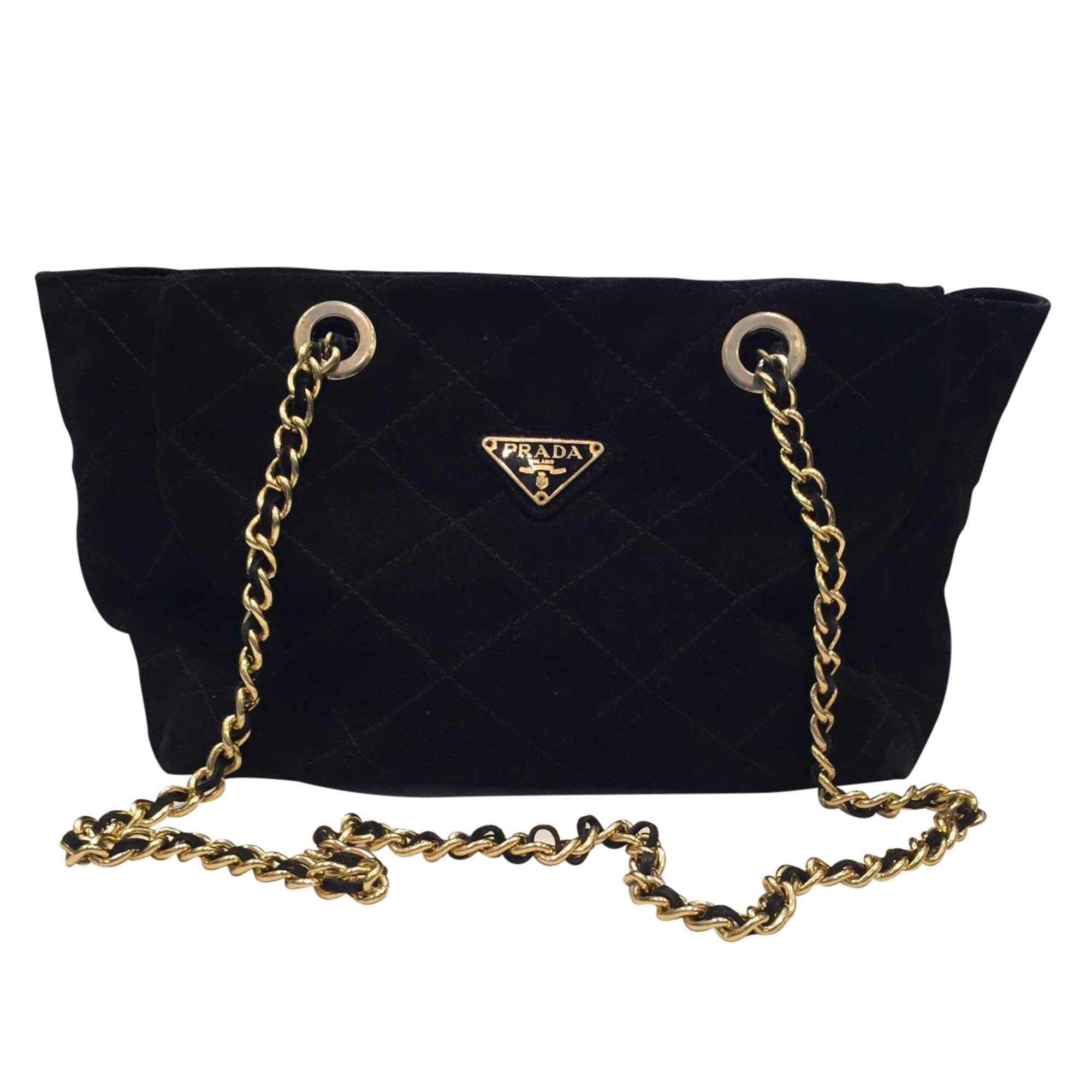Vintage classic Prada  bag in black suede and gold metal long chain
Zip closure. Interior in black monogrammed fabrics. 
2 handles in gold metal and leather
Color: Black
Lenght: 26 cm / 10,23 inches
Height: 24 cm / 9,44 inches
Depth: 10 cm / 3,93