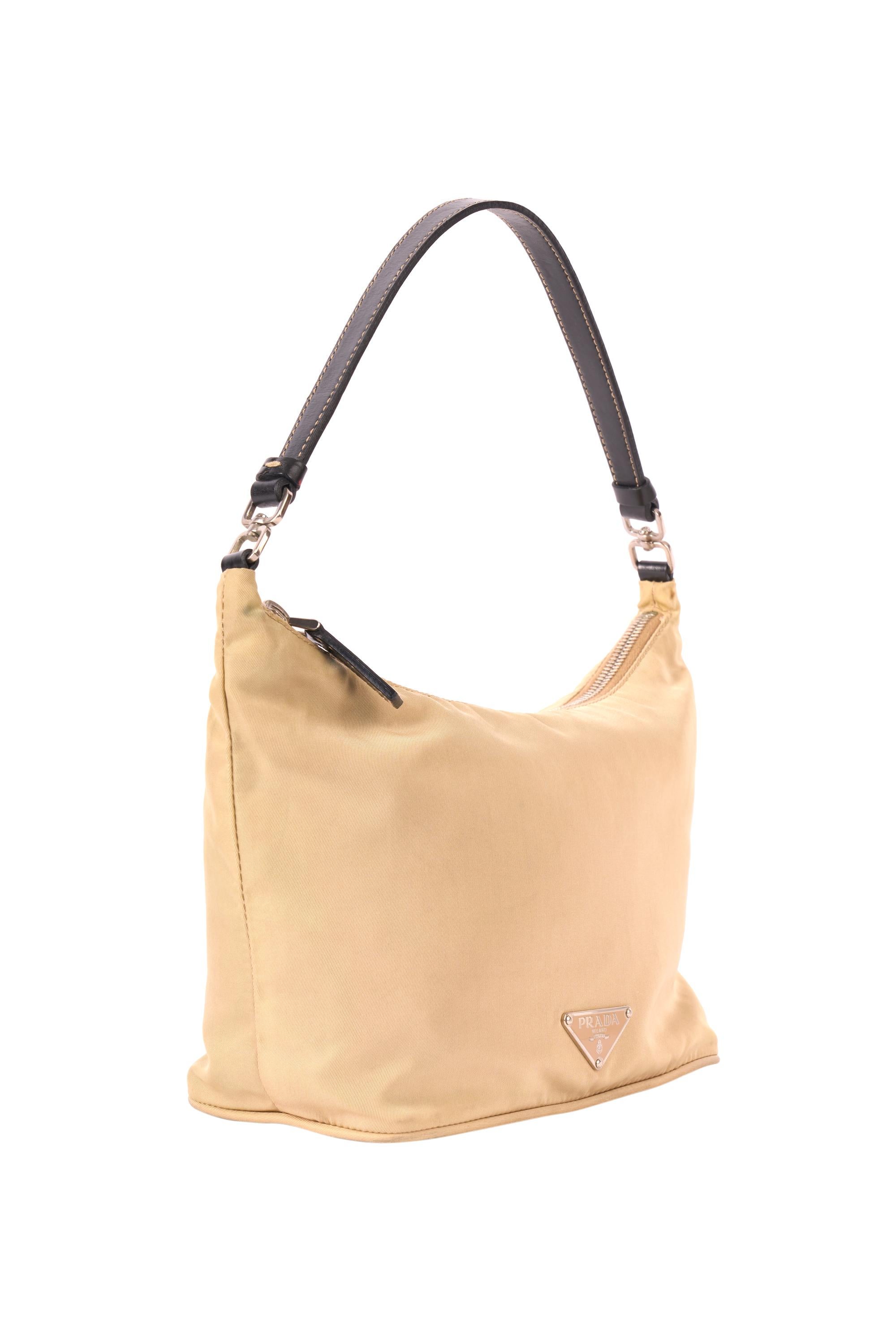 Prada 1990’s Tessuto beige city bag. Features Prada hardware, black leather strap, inside zip back pocket. In excellent condition.

Brand: Prada
Color: Beige
1990’s
City bag
Fabric: Nylon
Dustbag: No
Serial Number: 31
Measurements: Length: 10