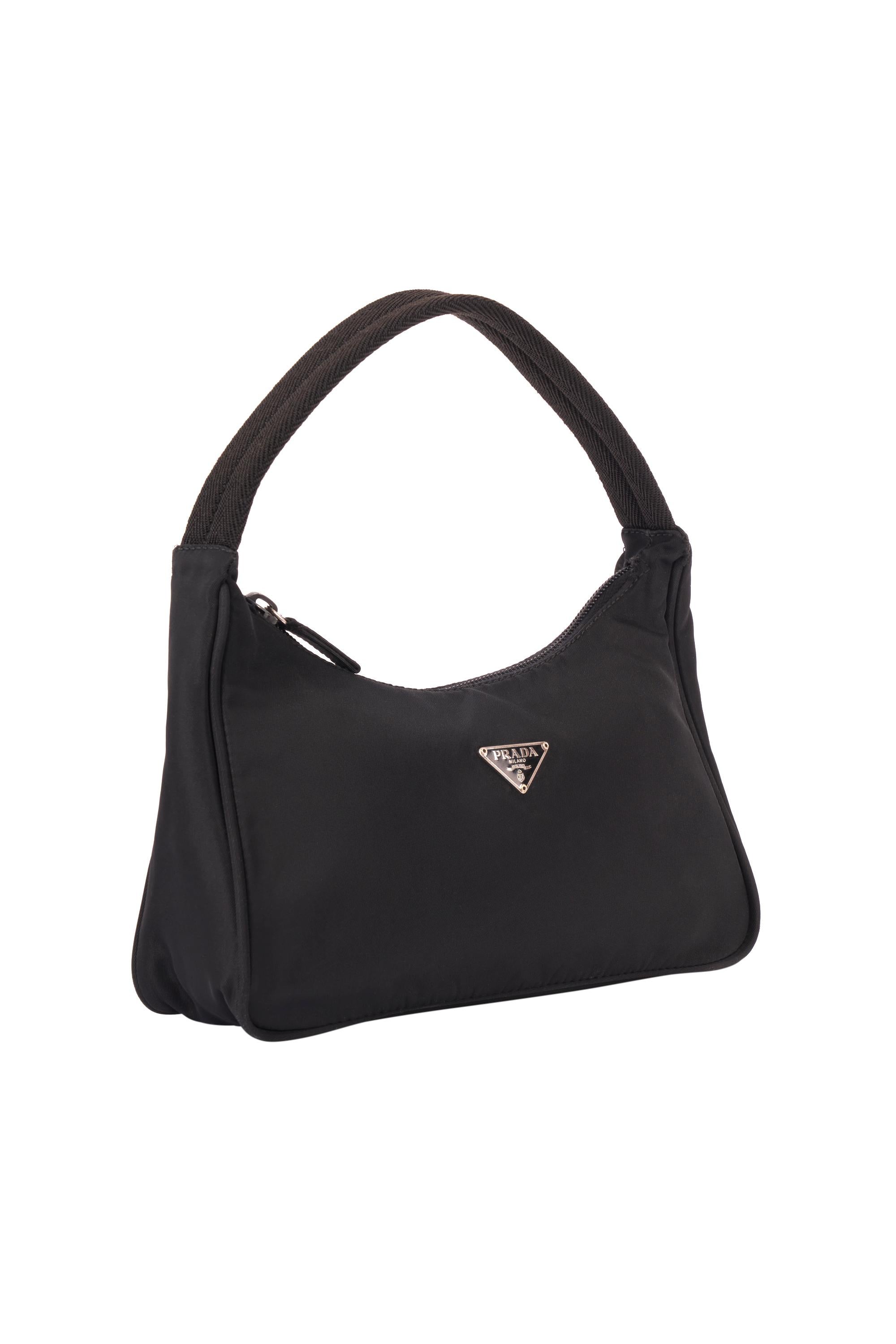 Vintage Prada 1990's black hobo nylon handbag.Features Prada hardware, and zip closure.  In excellent condition.

Brand: Prada
Color: Black
Hobo Bag
Fabric: Nylon
Dustbag: No
Serial Number: 31
Measurements: Length: 9 inches, Height: 6 inches, Width:
