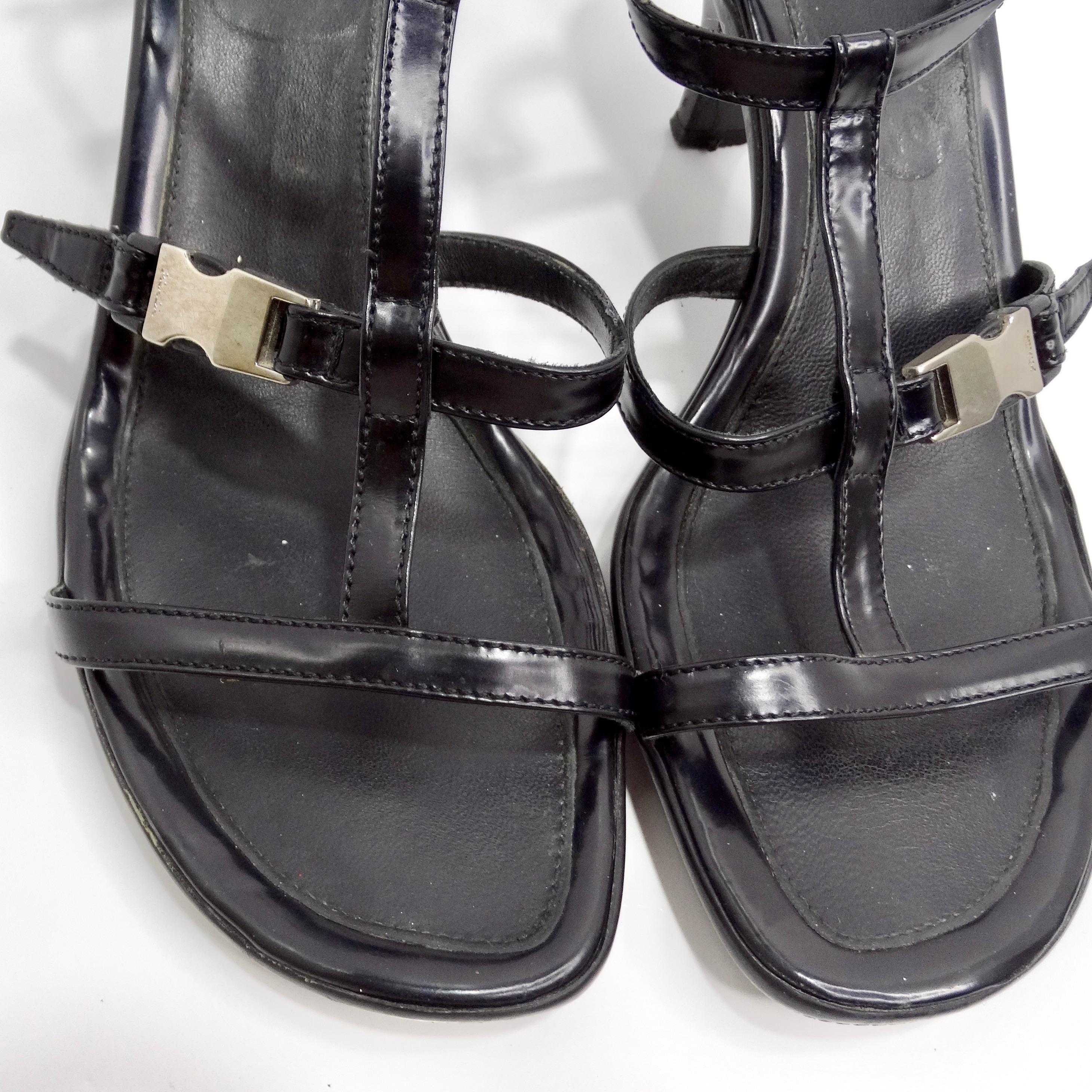 Introducing the timeless elegance of the Prada Vintage Black Leather Strappy Buckle Kitten Heels, a chic and versatile footwear option perfect for any occasion. Crafted from luxurious black leather, these sandals feature a striking multi-strap