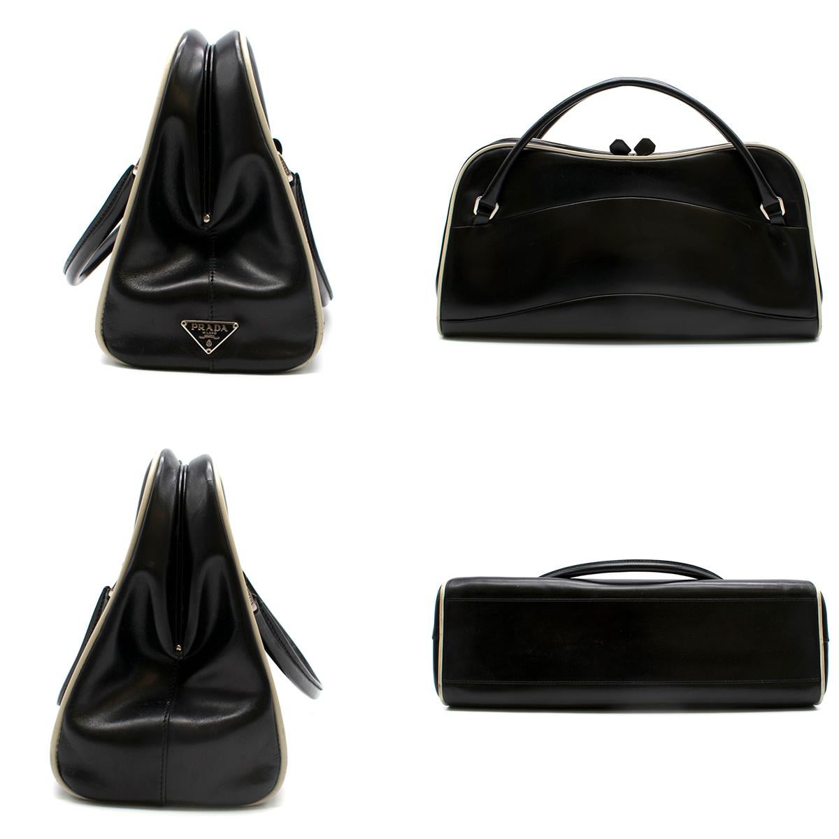 Prada Vintage Black Polished Leather Medium Handle Bag 

- Smooth leather material
- Fine leather white lining 
- Wide handle for better grip 
- Half frame fringe with a open/close clasp 
- Interior zip
- Fine interior material

Please note, these